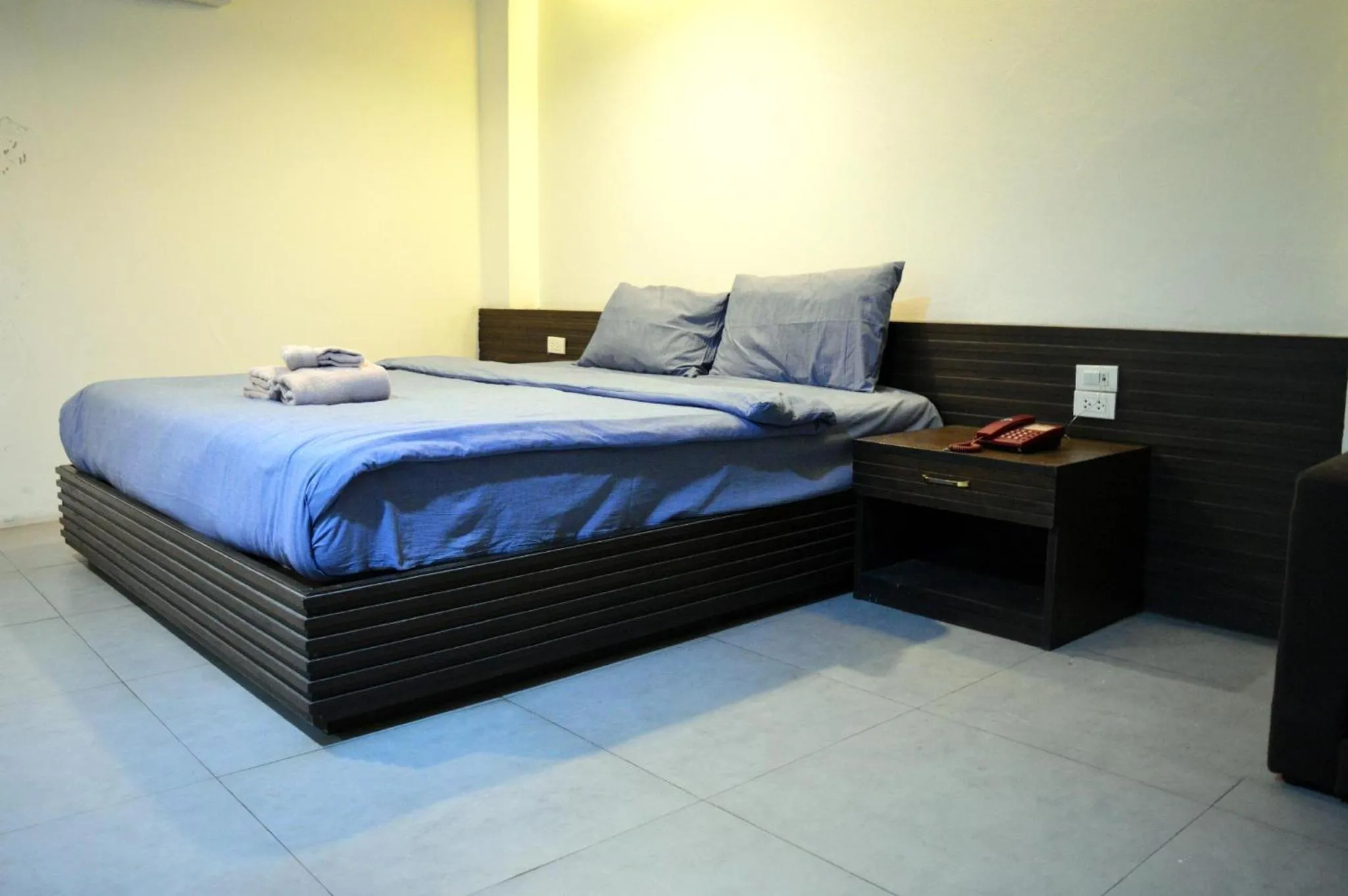 Bed in De Nawarat Chiangmai Boutique Apartment