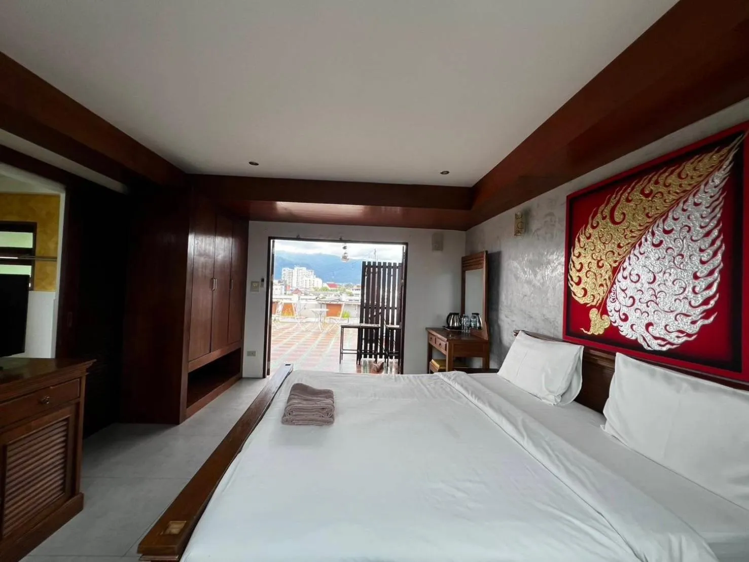 Bed in De Nawarat Chiangmai Boutique Apartment