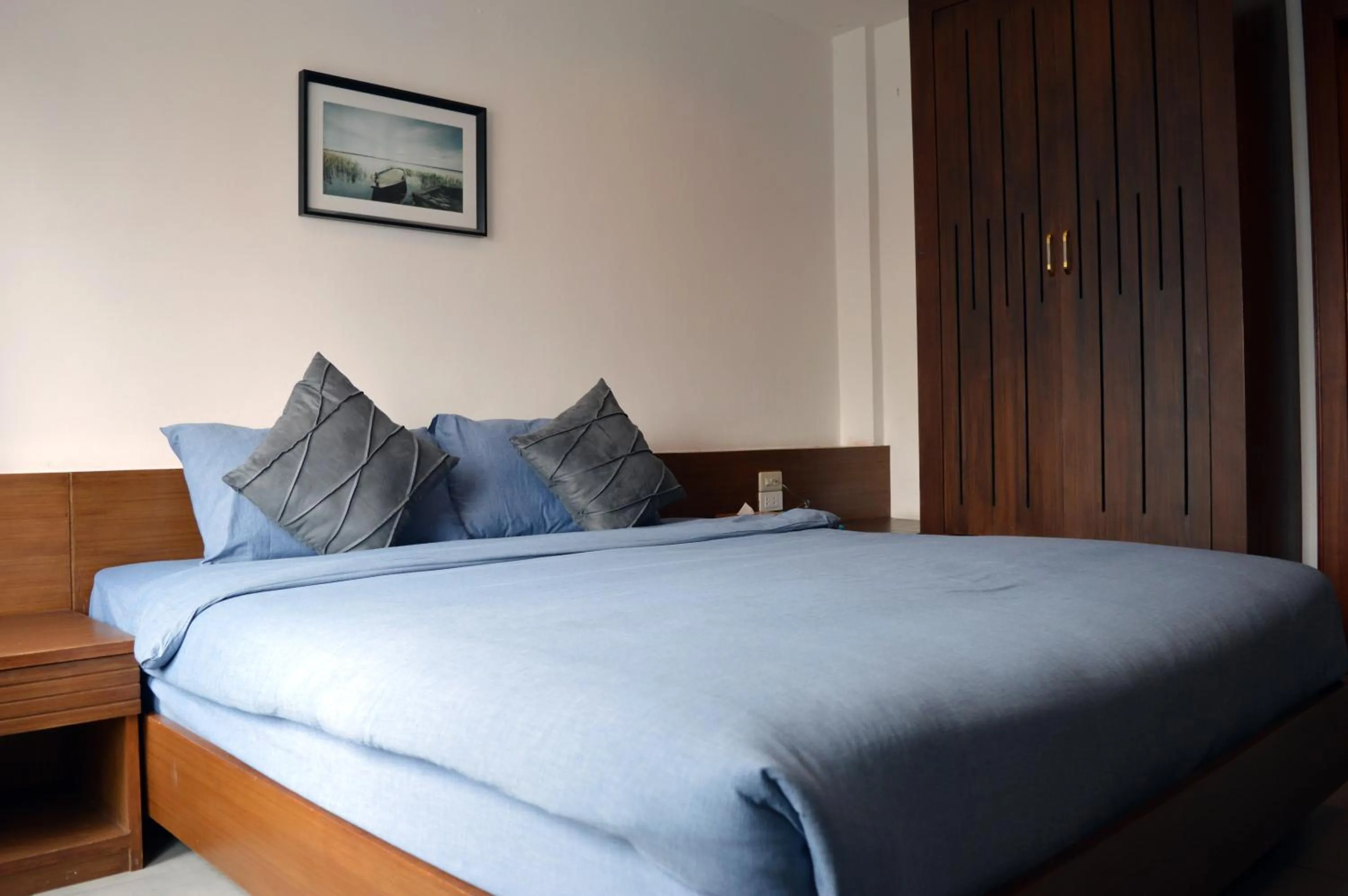 Bed in De Nawarat Chiangmai Boutique Apartment