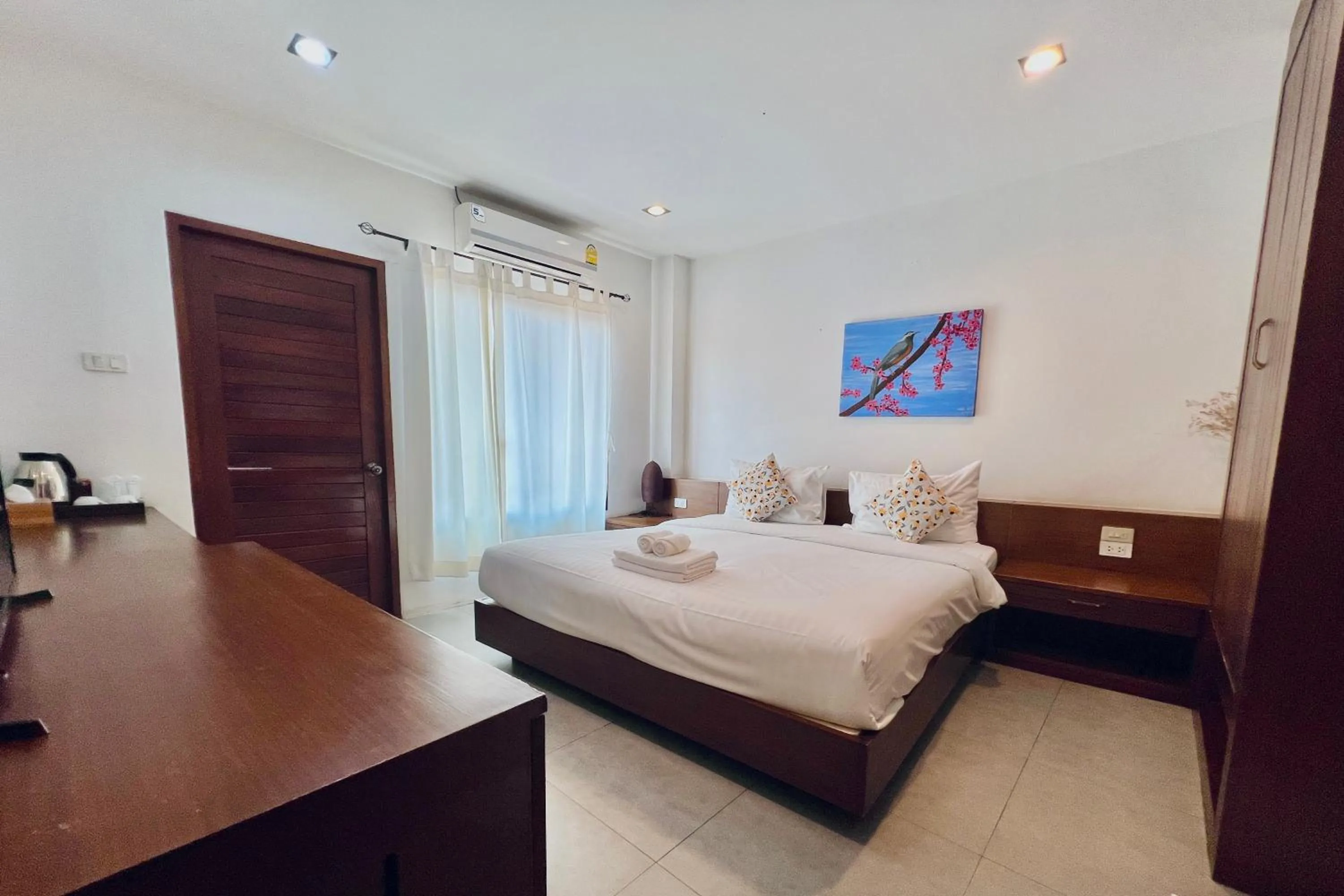 Bed in De Nawarat Chiangmai Boutique Apartment