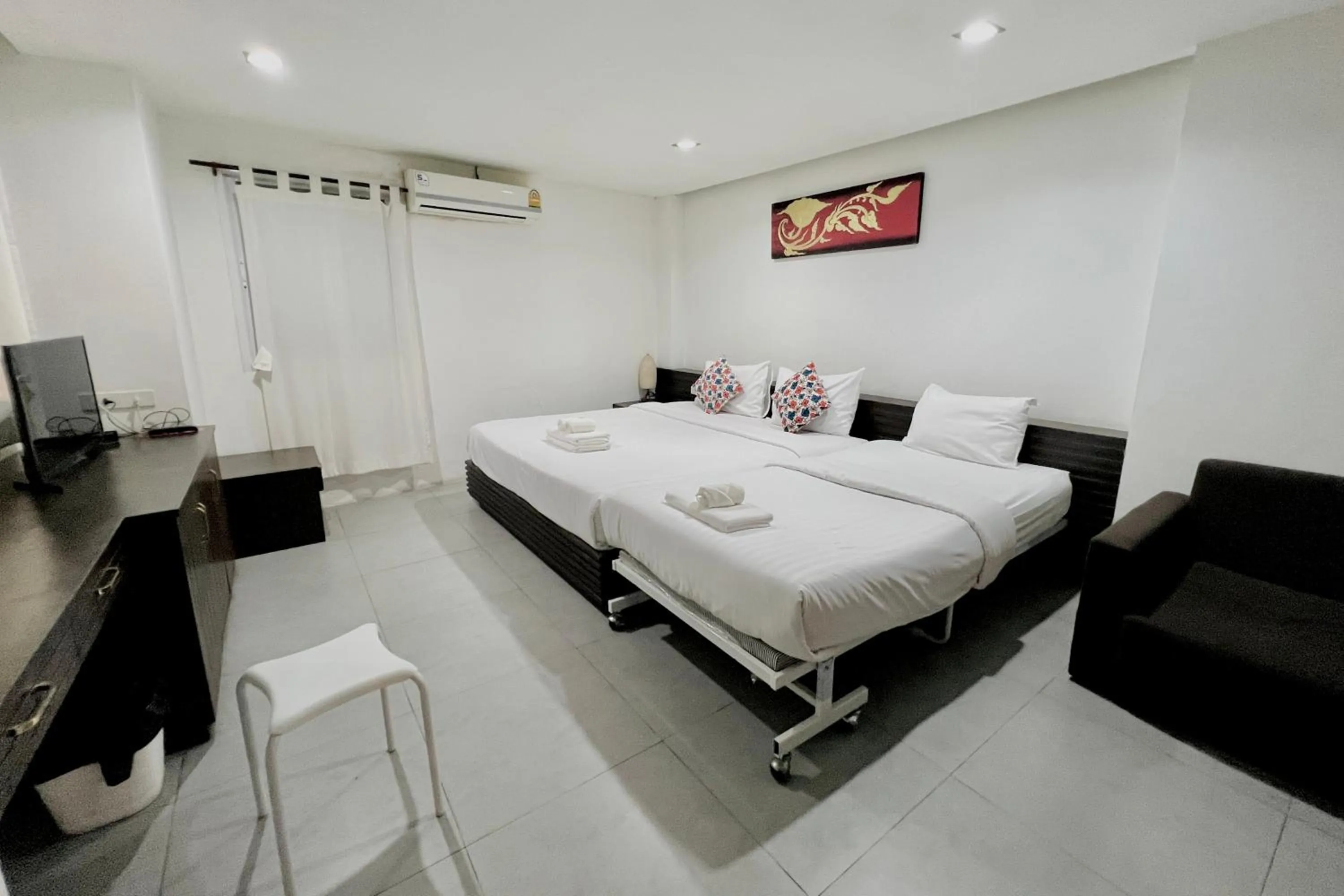 Bed in De Nawarat Chiangmai Boutique Apartment