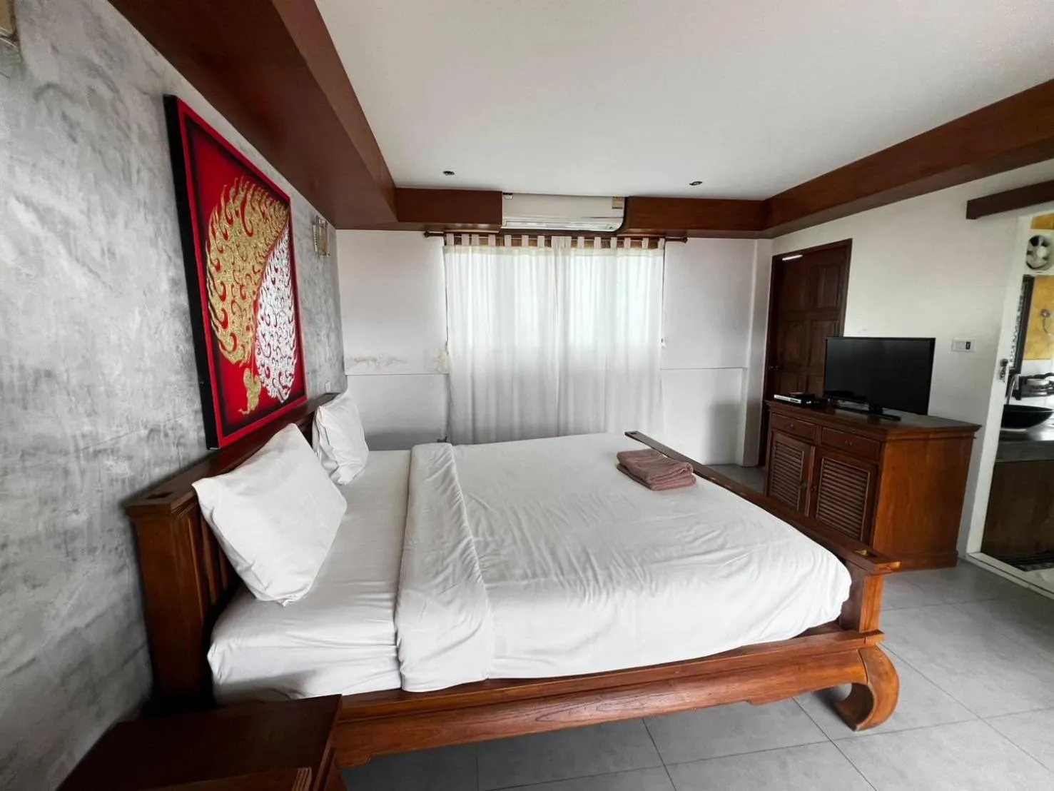 Bed in De Nawarat Chiangmai Boutique Apartment