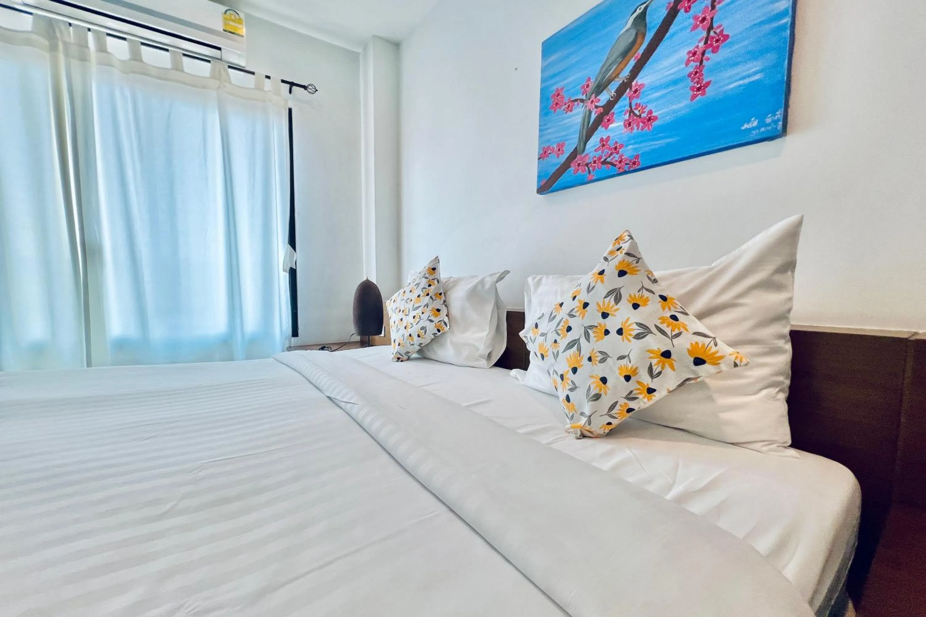 Bed in De Nawarat Chiangmai Boutique Apartment