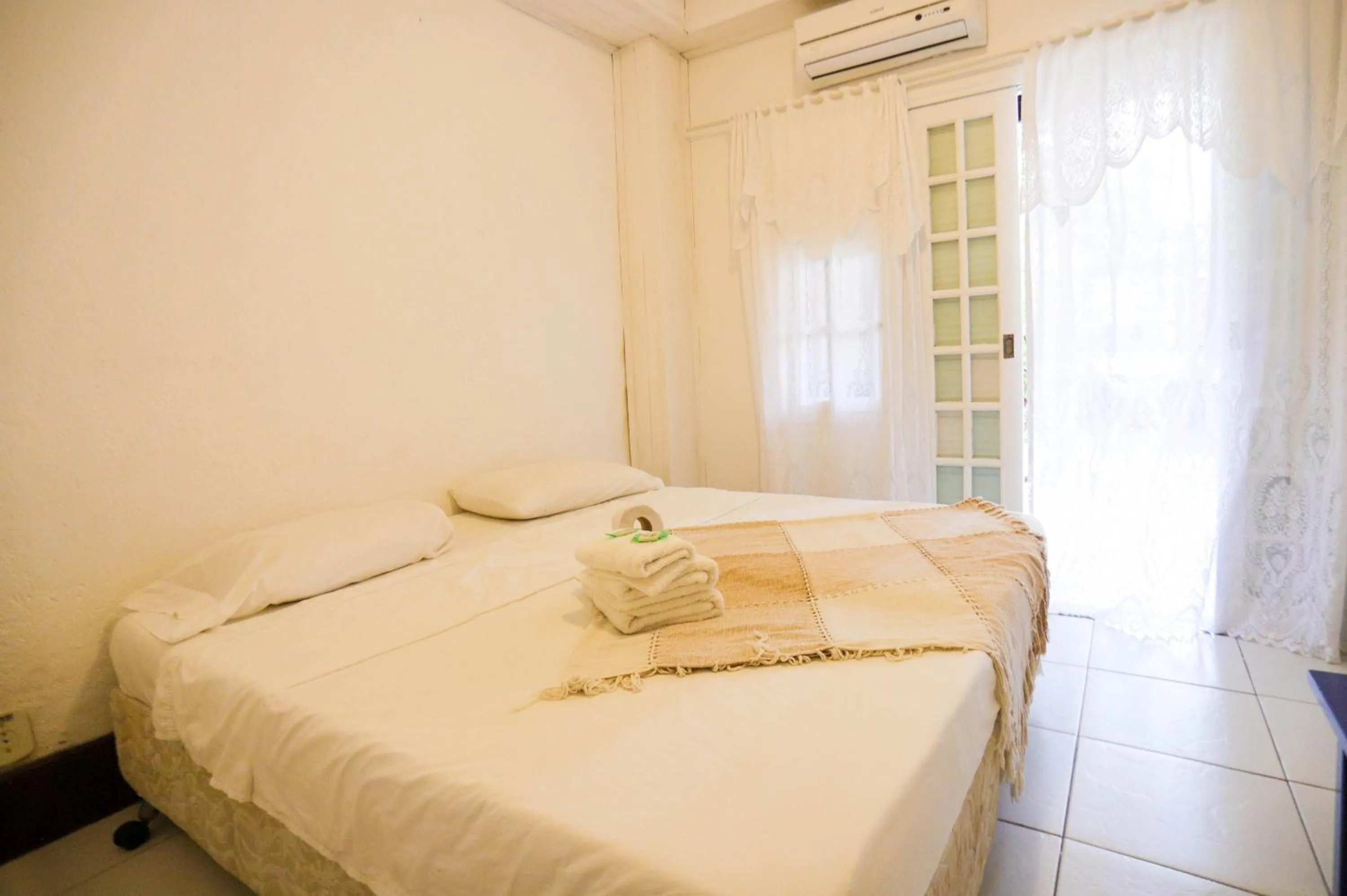 Bed in POUSADA AMENDOEIRA