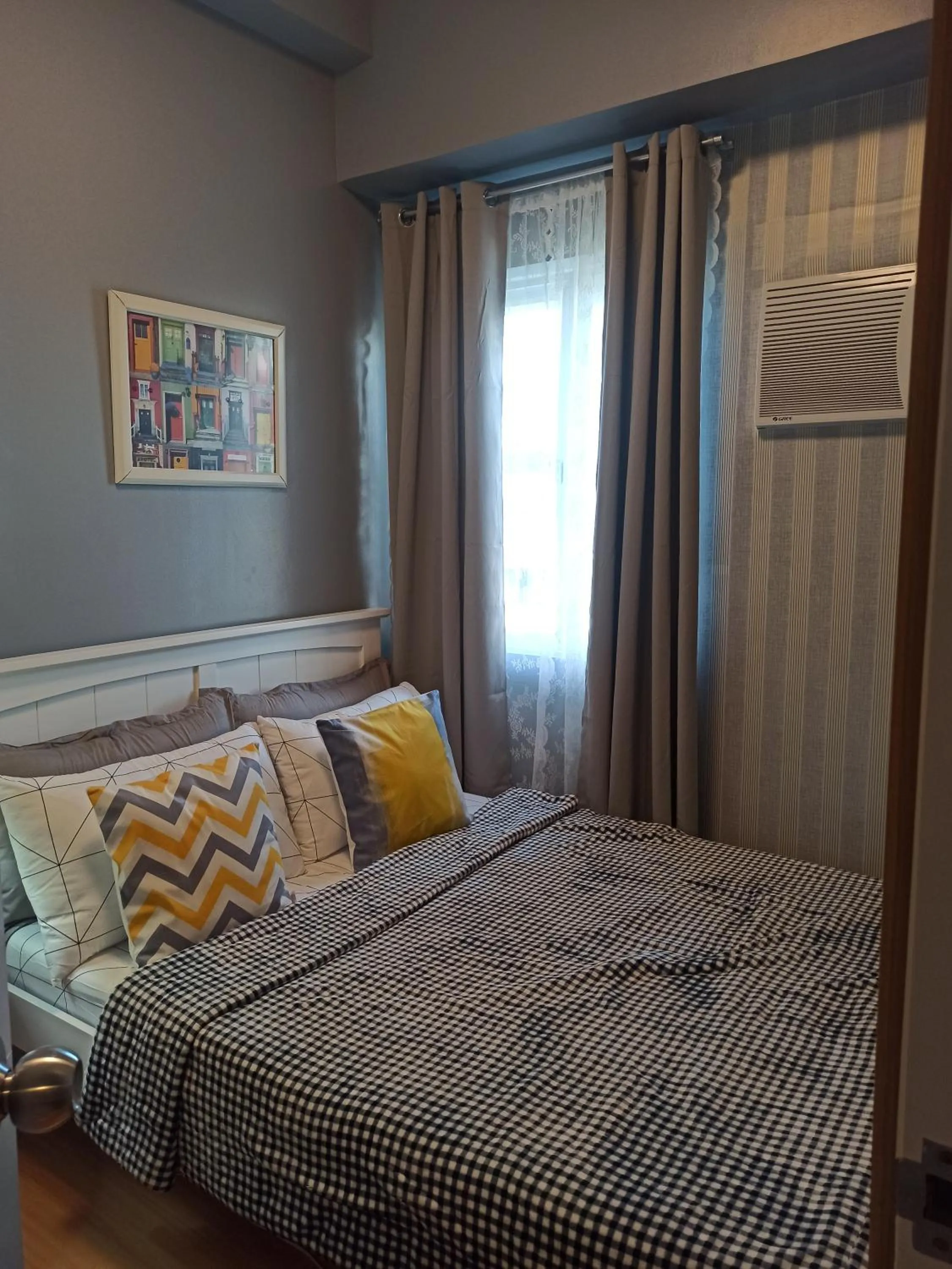 Bedroom in 2-Bedroom CK's Corner Staycation Trees Residences