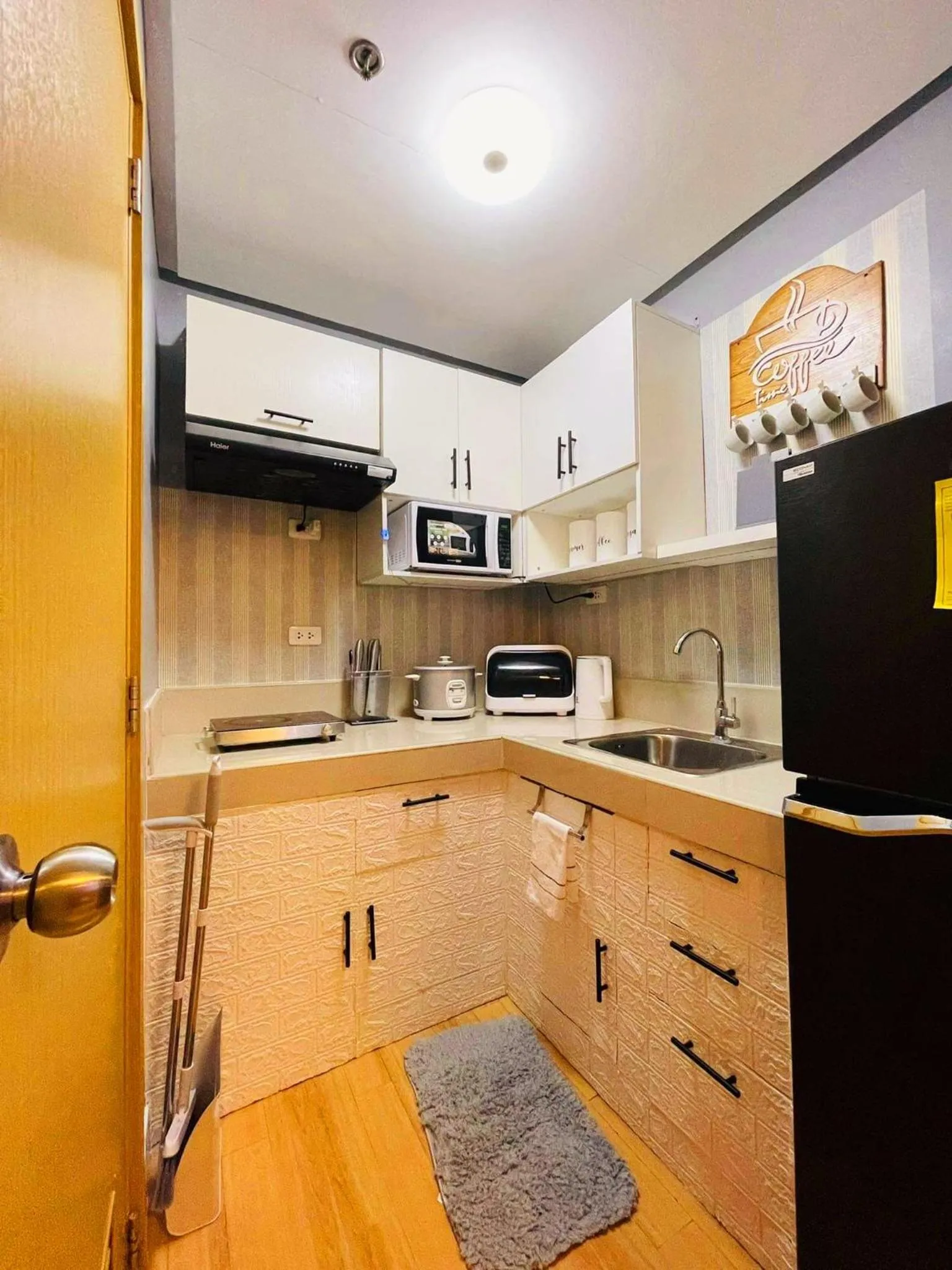 Kitchen or kitchenette in 2-Bedroom CK's Corner Staycation Trees Residences