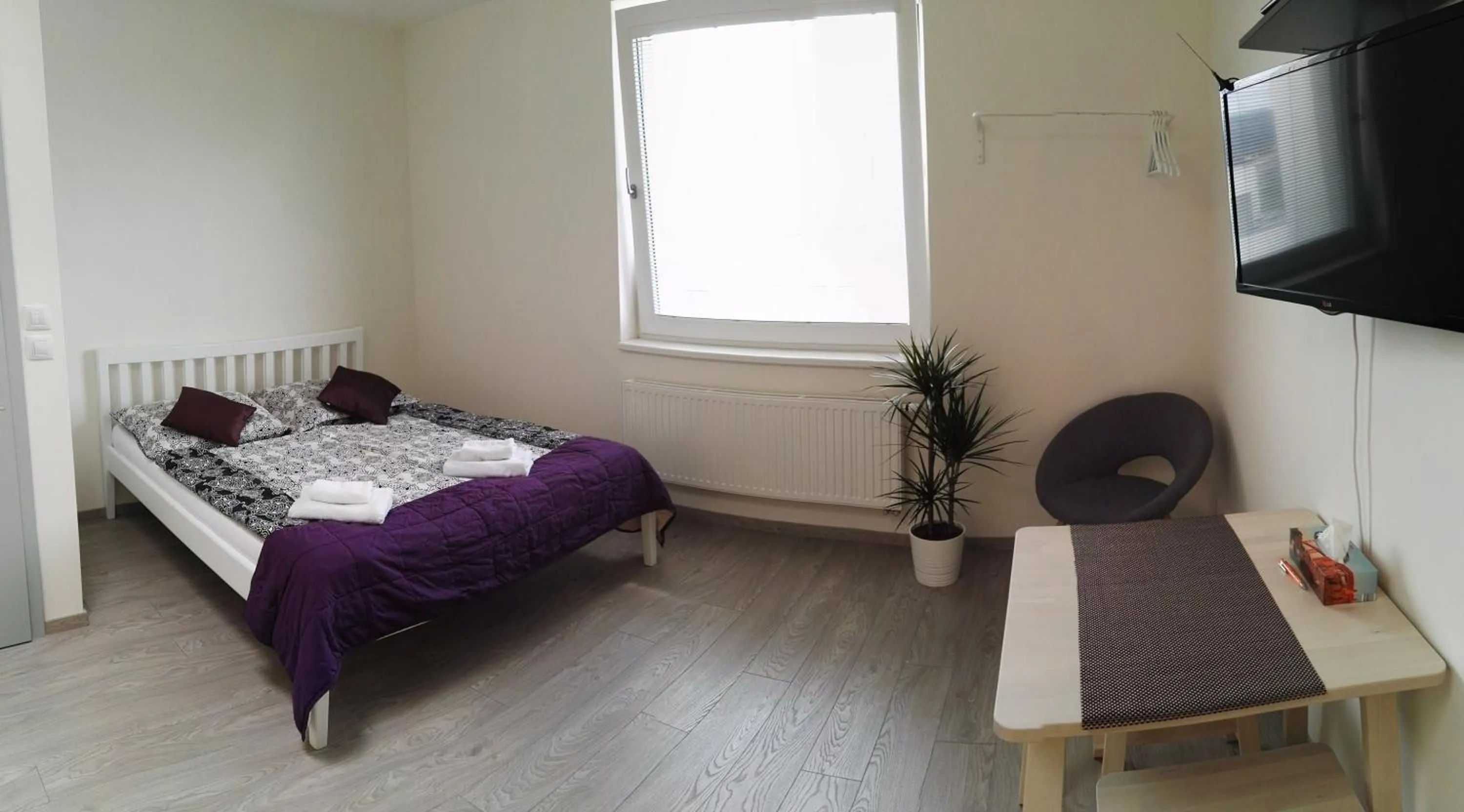 Communal lounge/ TV room, Bed in Alfa Panorama Brno