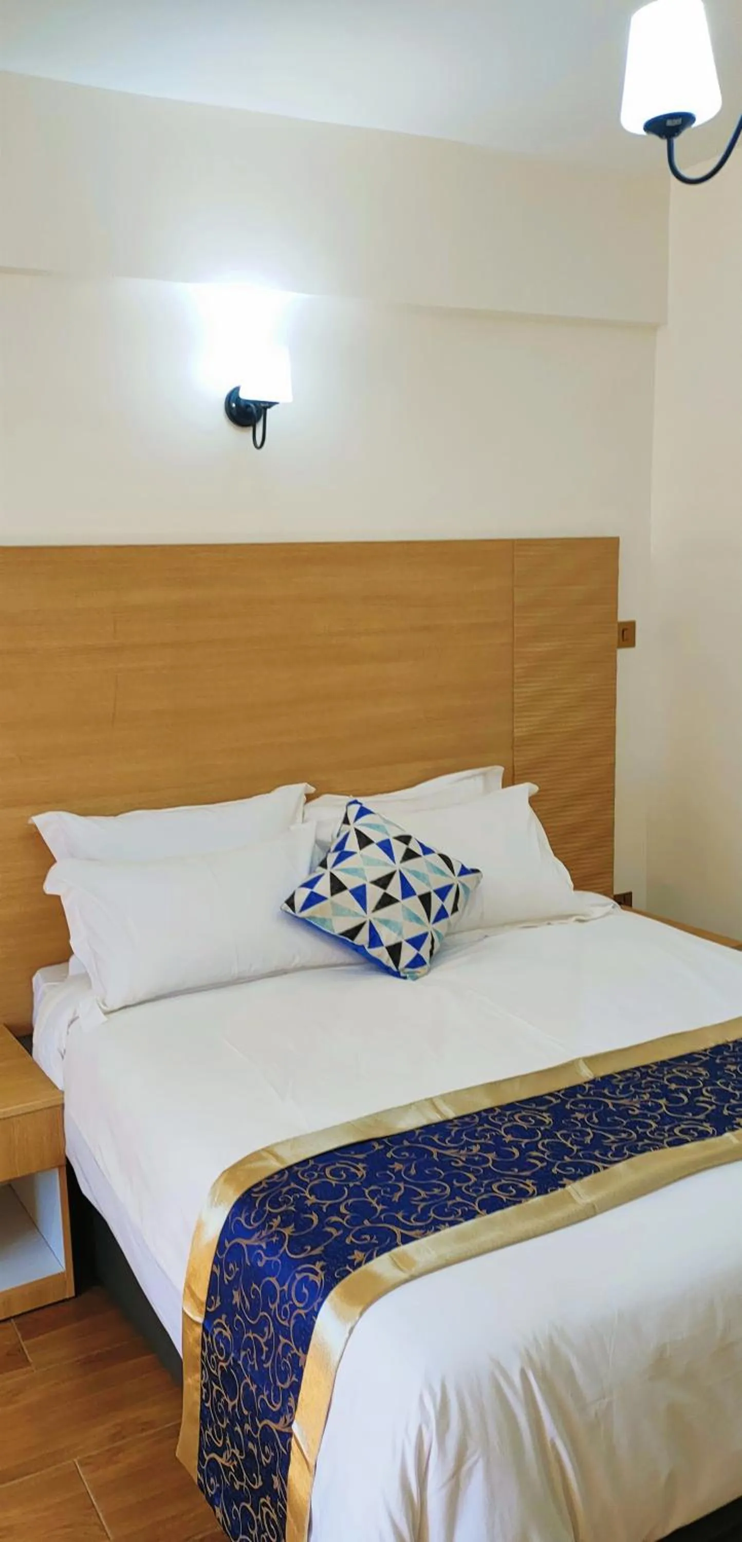 Bed in Hays Suites Hotel