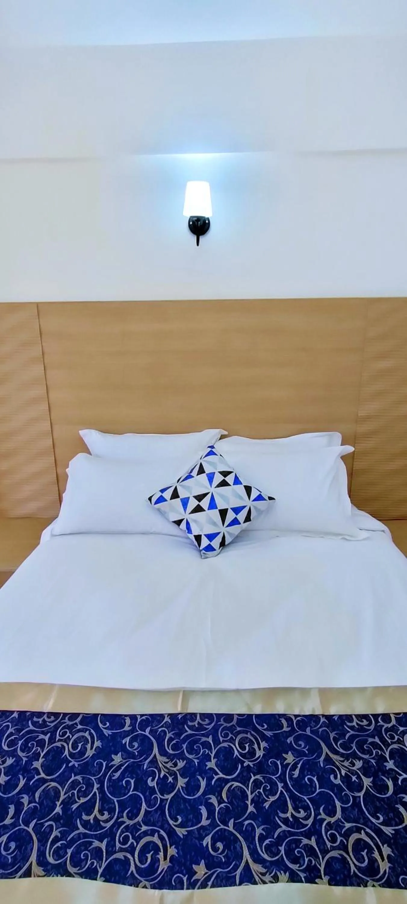 Bed in Hays Suites Hotel