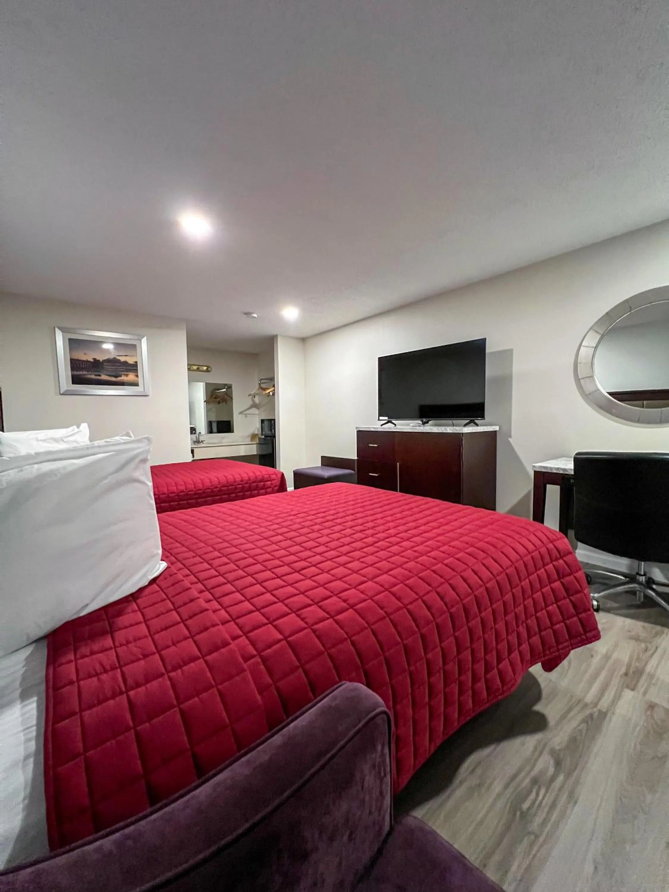 Bed in Garden Inn & Suites