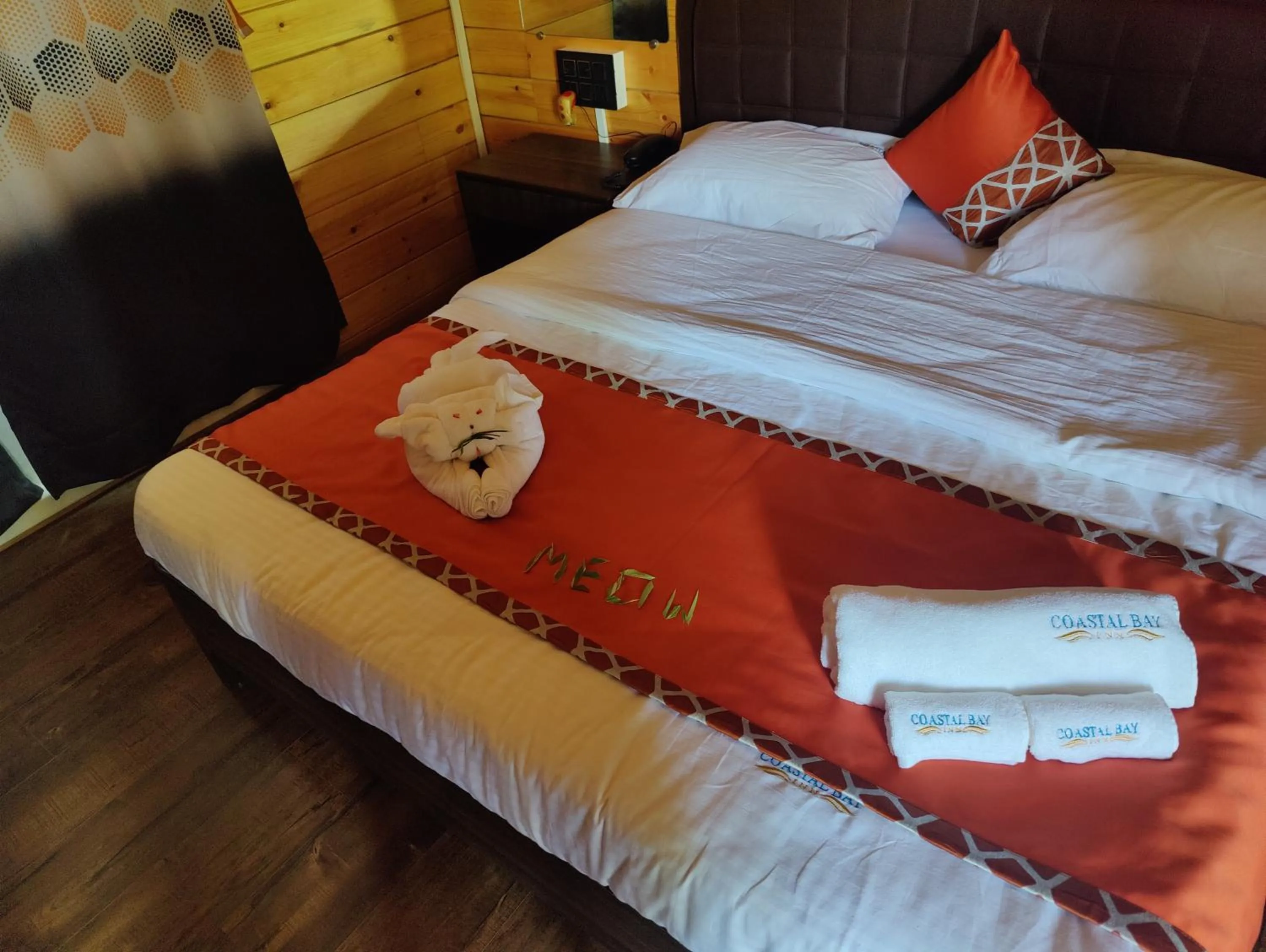 Bed in Coastal Bay Inn by Green Apple Stays