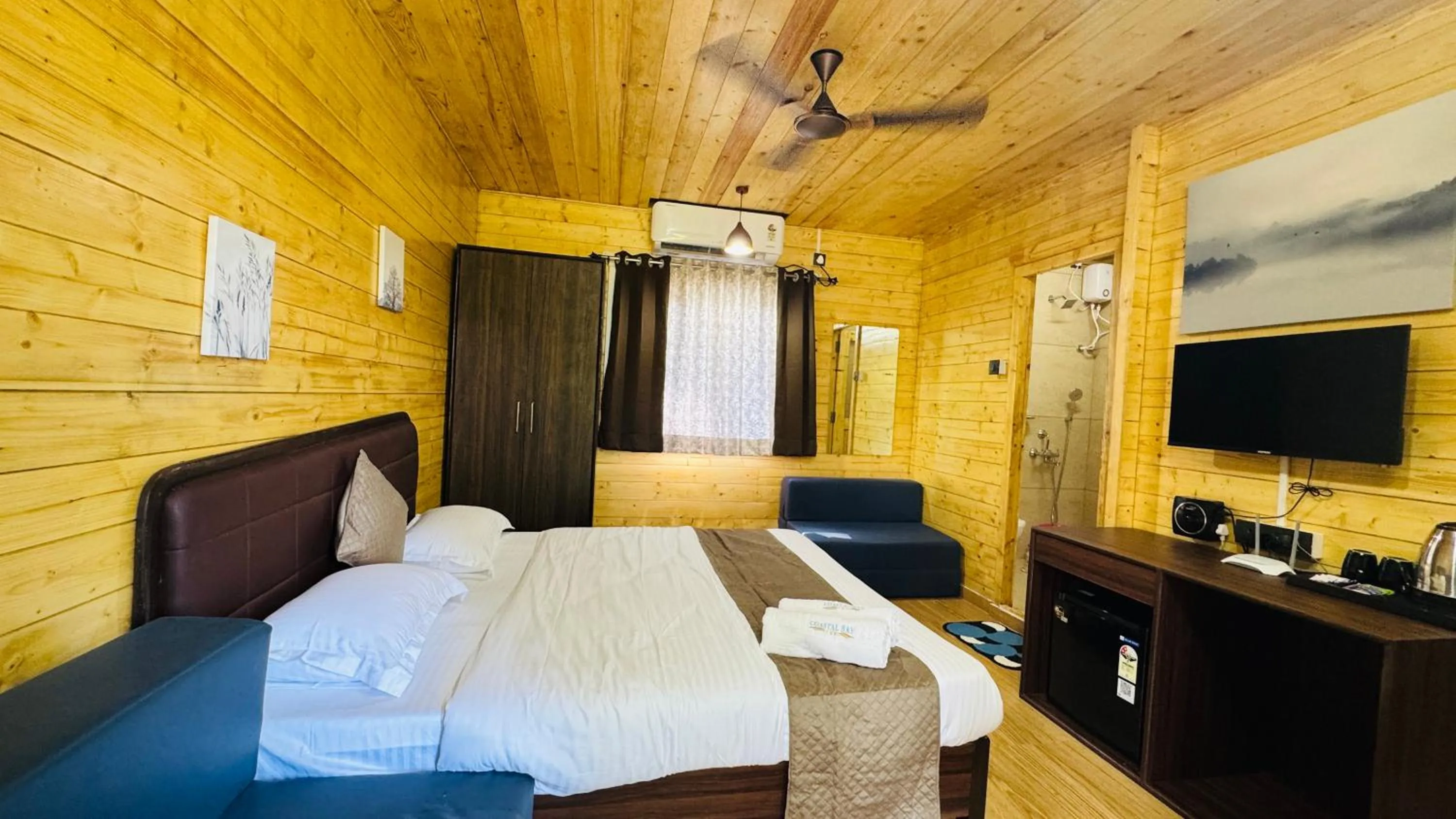 Bed in Coastal Bay Inn by Green Apple Stays