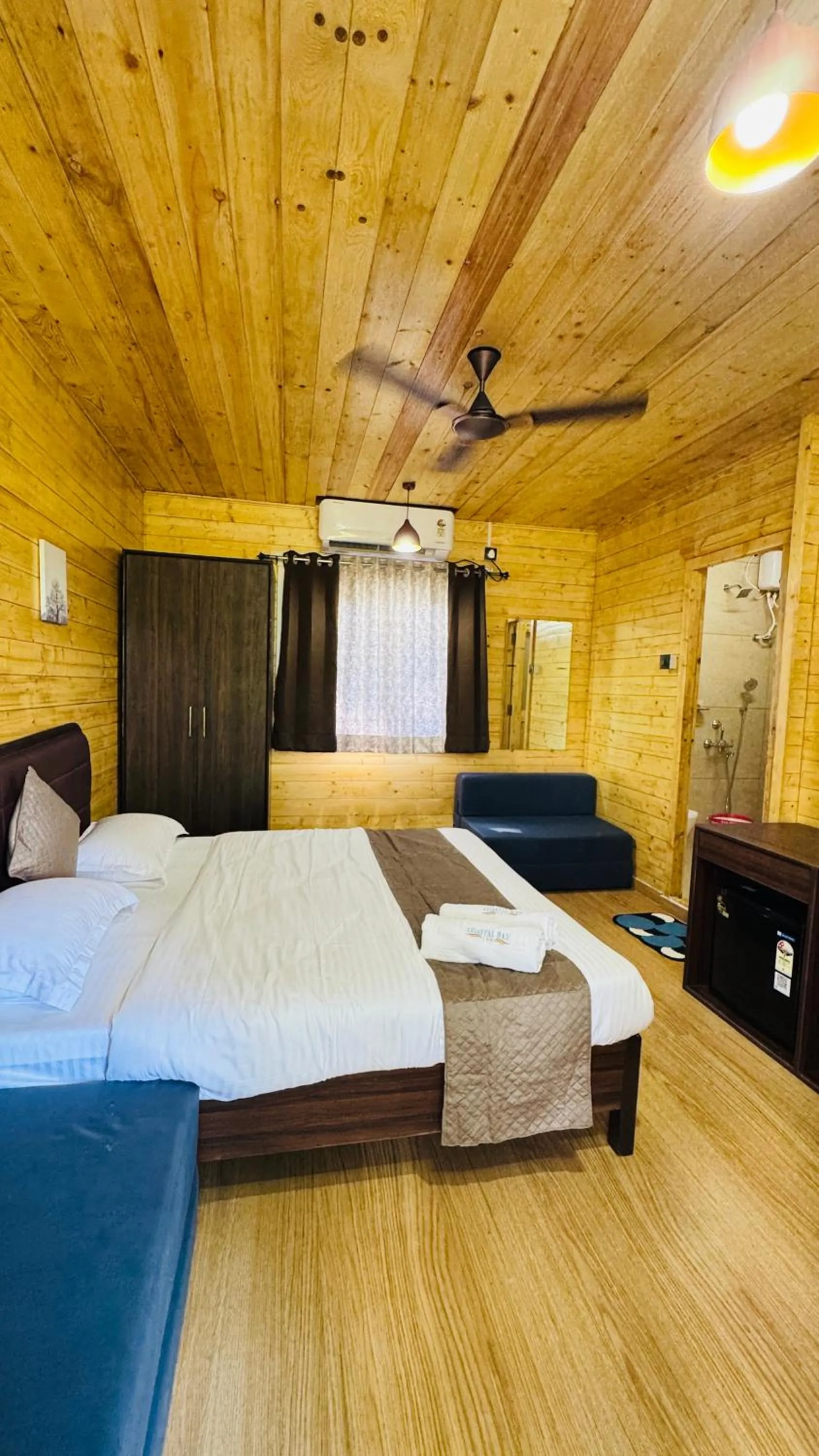 Bed in Coastal Bay Inn by Green Apple Stays