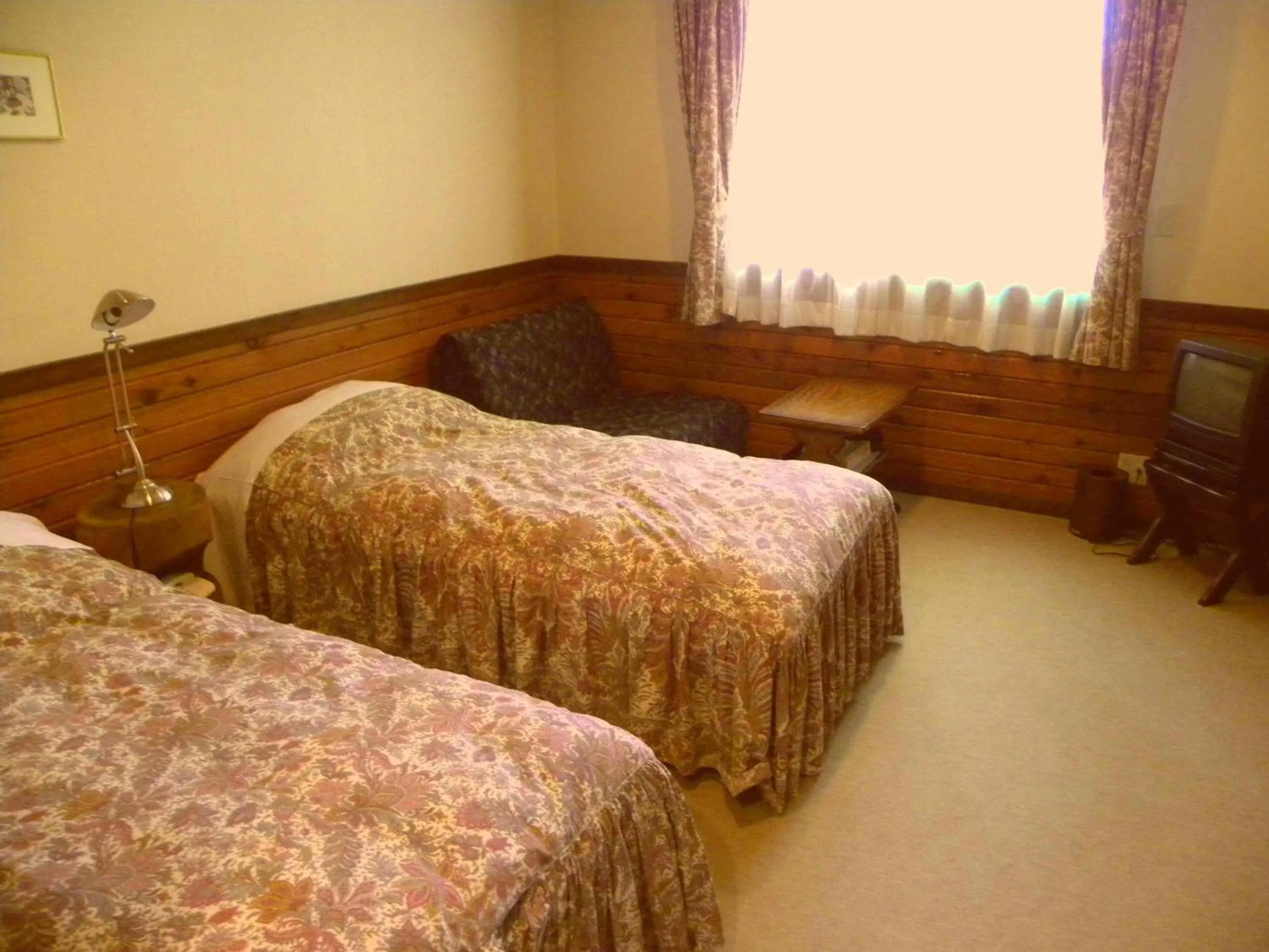 Bed in Petit Hotel Kazekozou