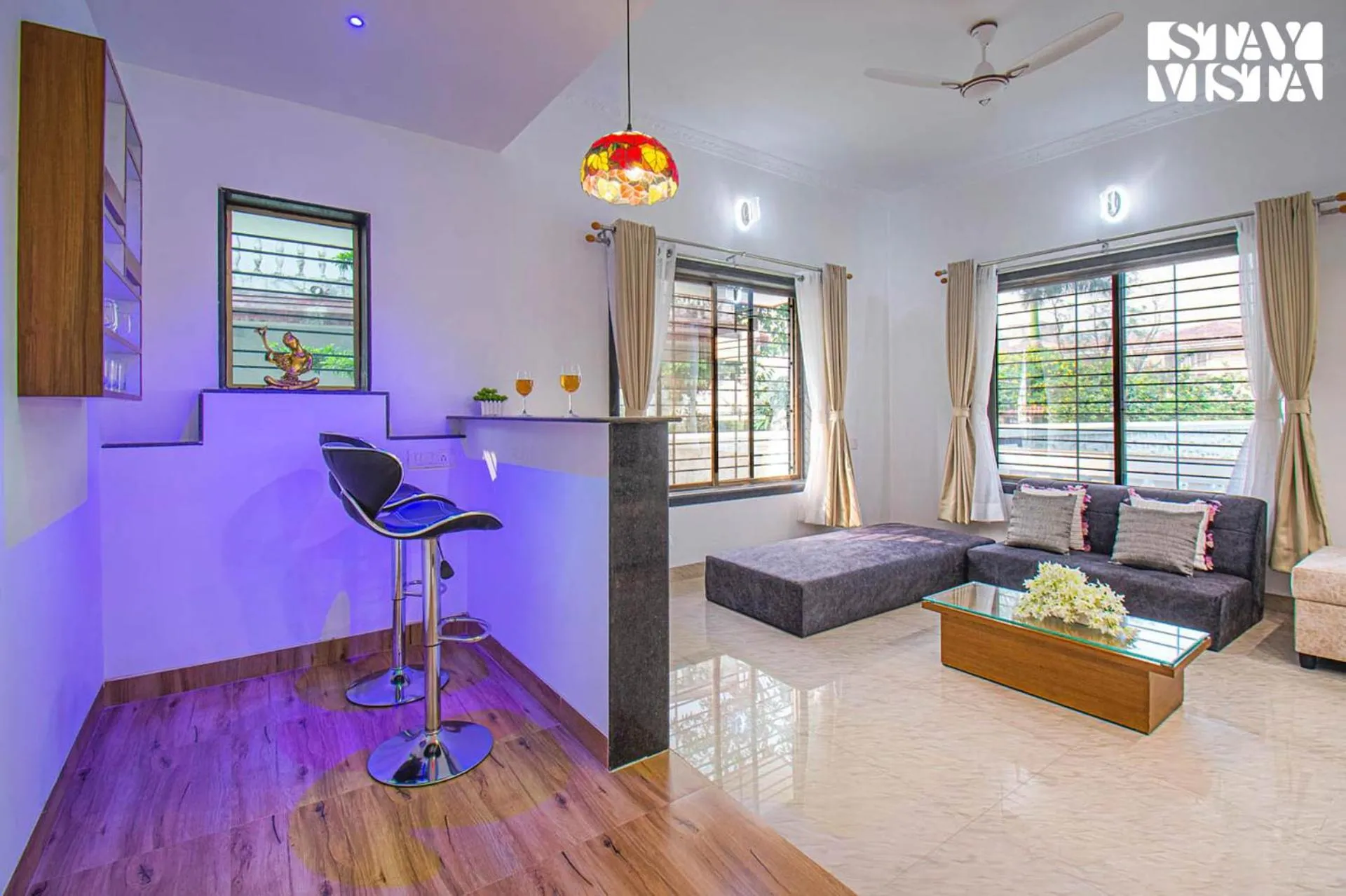 Living room in StayVista's Brookvale Cottage - Dive into tranquility with pool view and gazebo