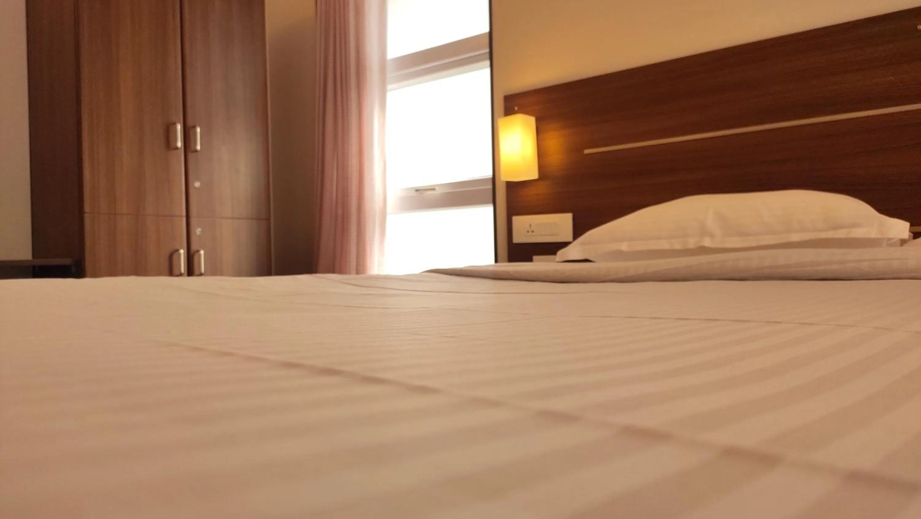 Bed in Hotel Rhythm Grand Suite