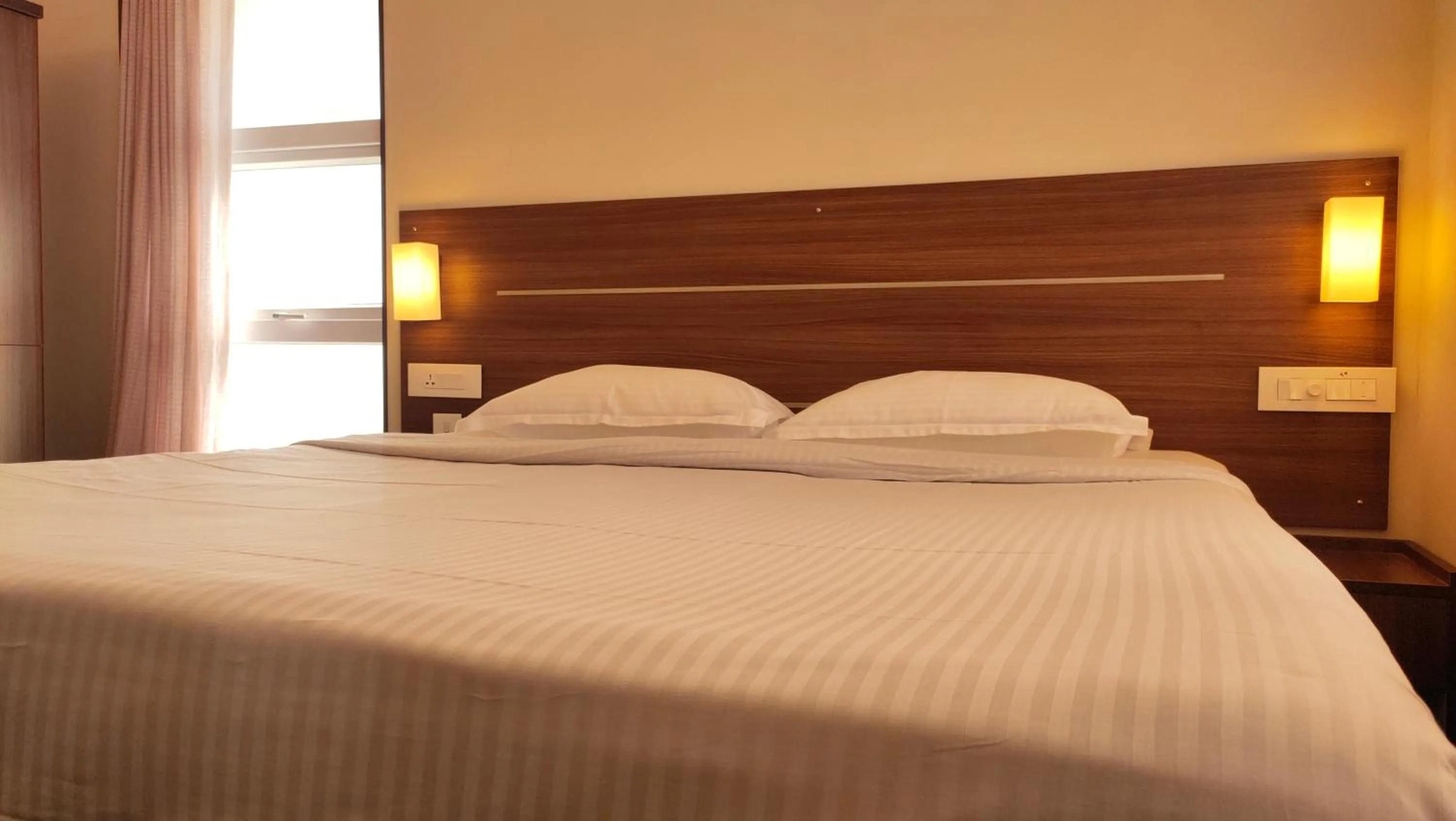 Bed in Hotel Rhythm Grand Suite