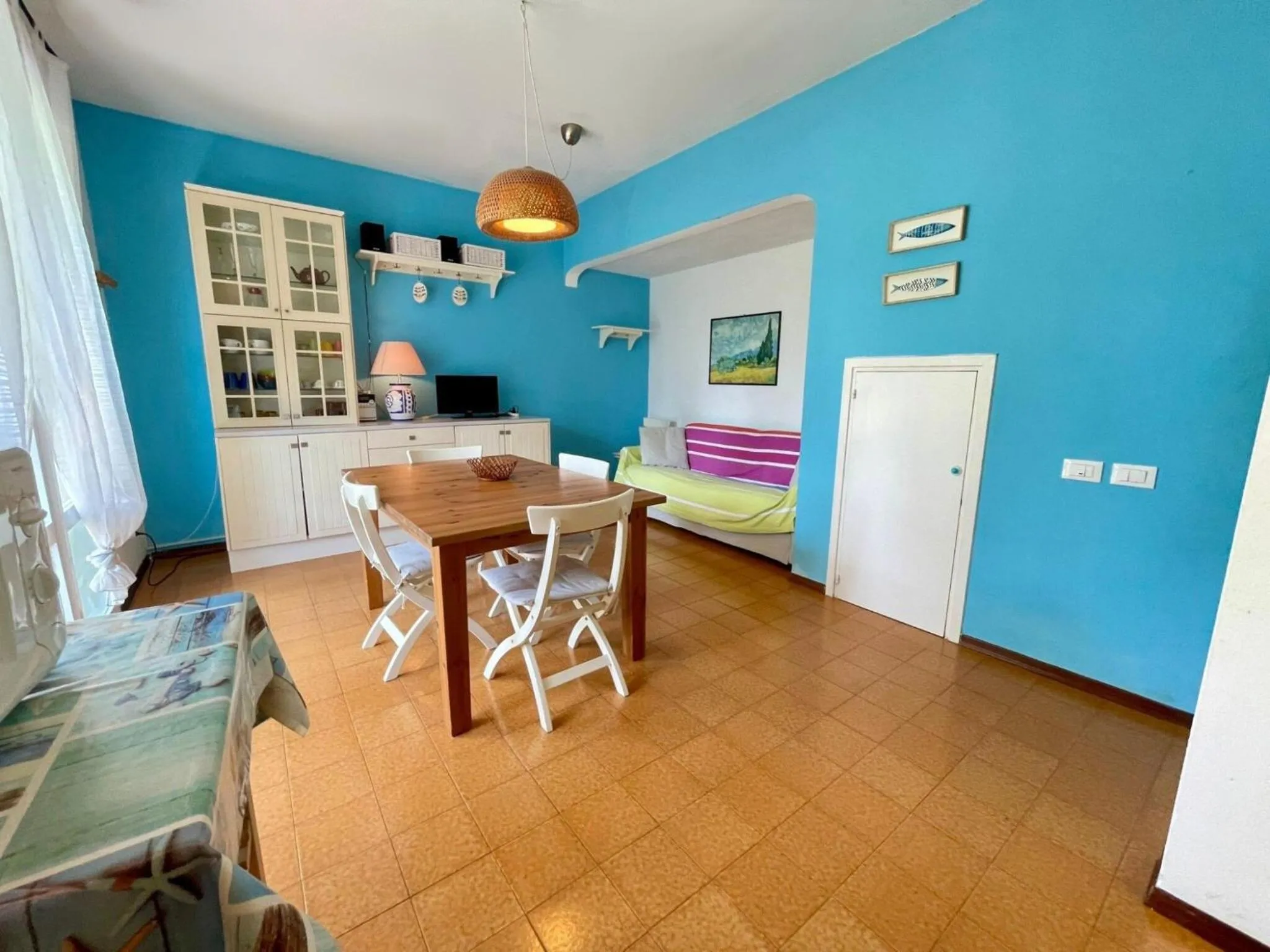 Dining area in Colorful house with pool and garden