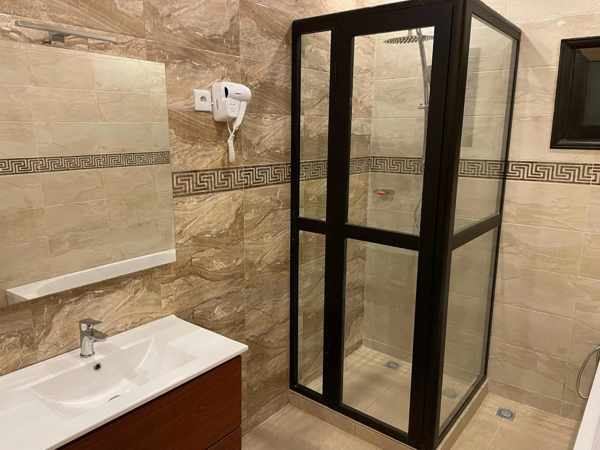 Shower in HOTEL LES ARCADES