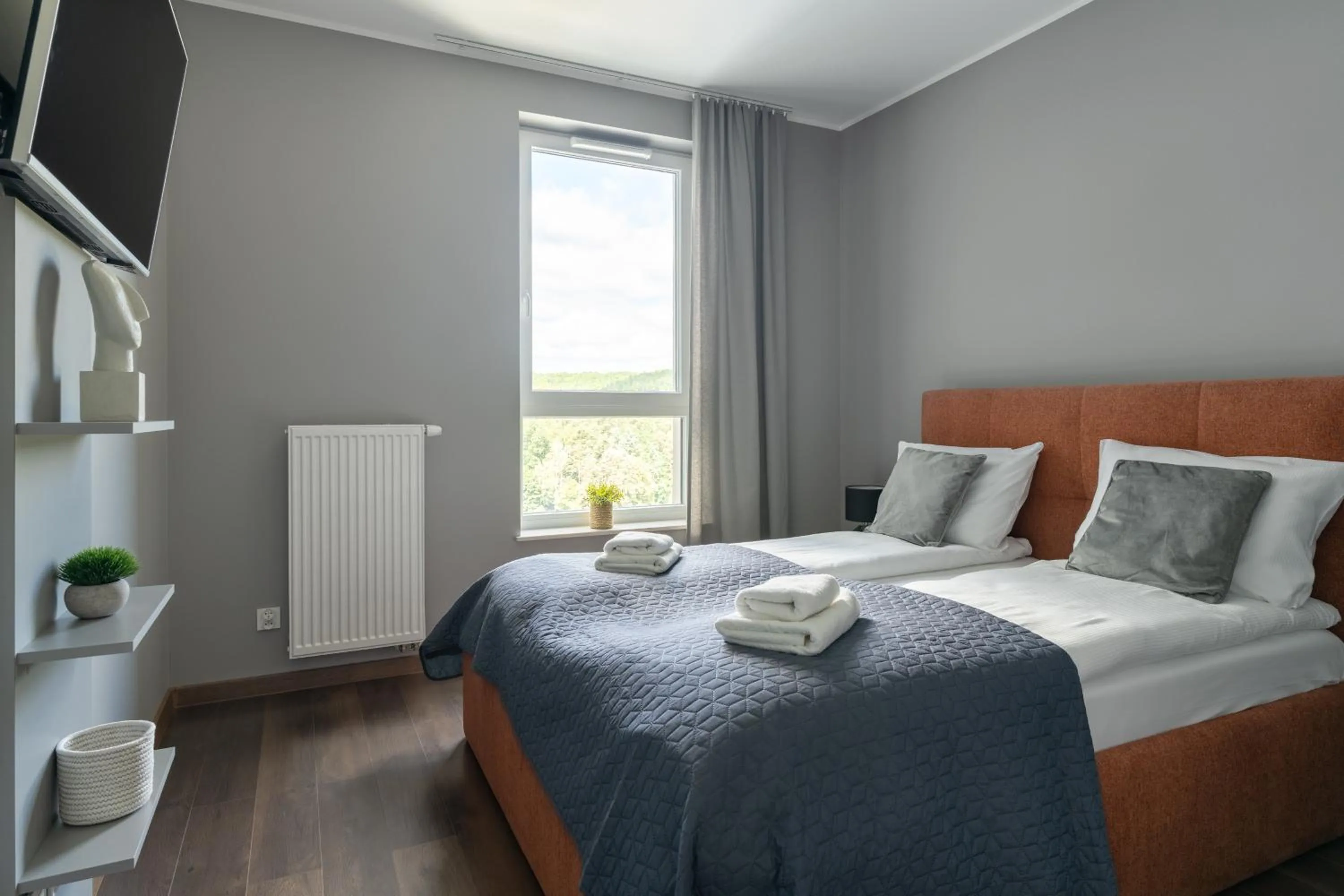 Bed in Symphony Modern Tower Apartamenty