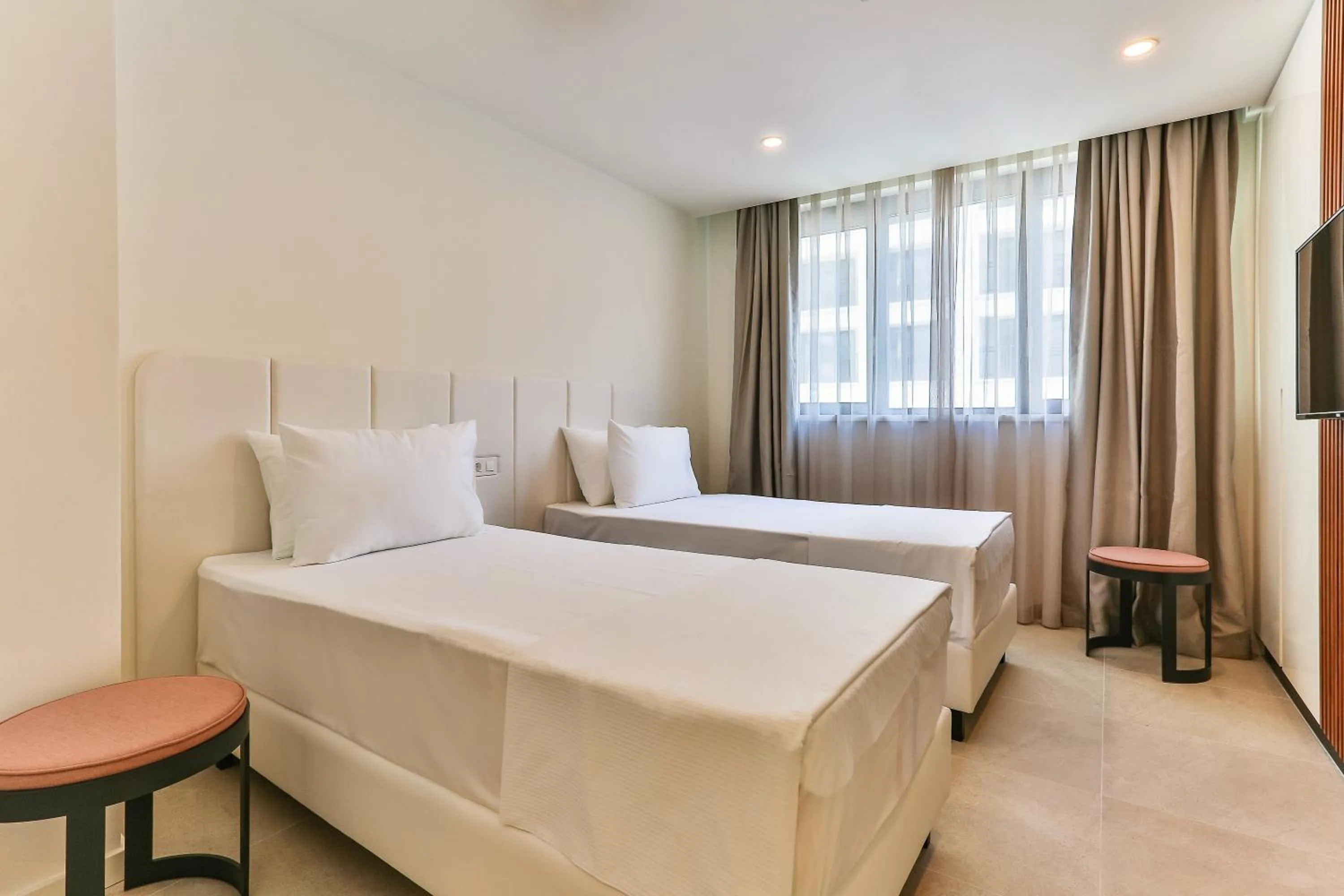 Bed in Sunraf Luxe Apartments