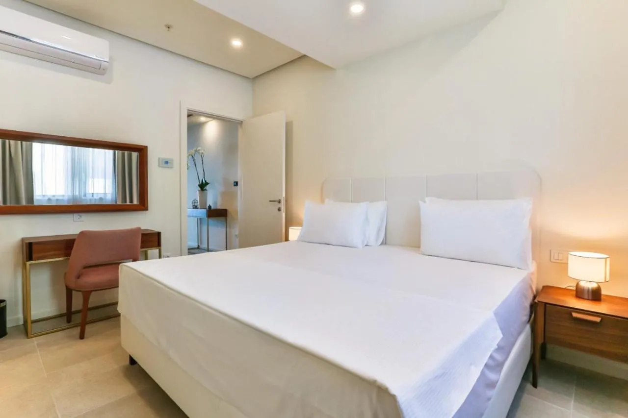 Bed in Sunraf Luxe Apartments