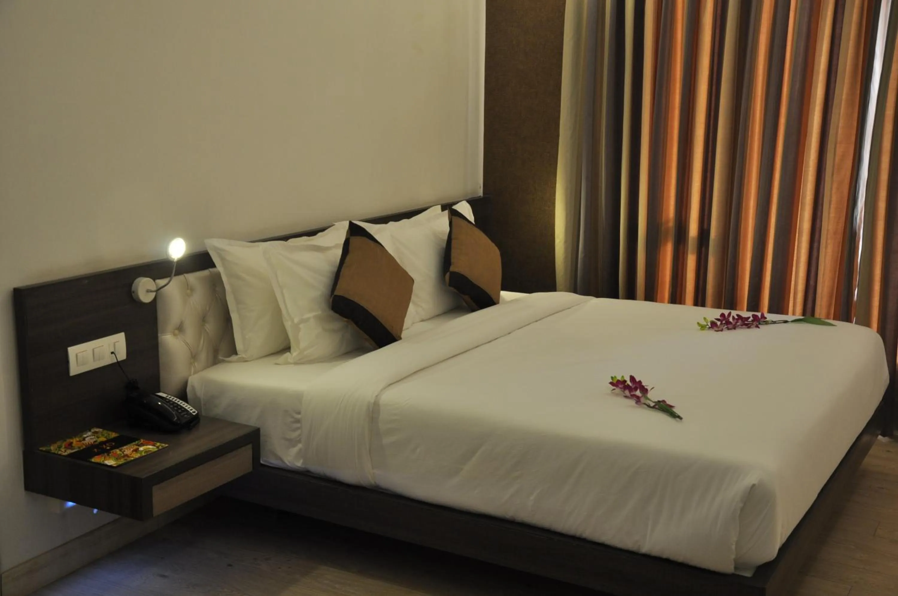 Photo of the whole room, Bed in Pride Biznotel Manjusar Vadodara Near Sokhda Lake