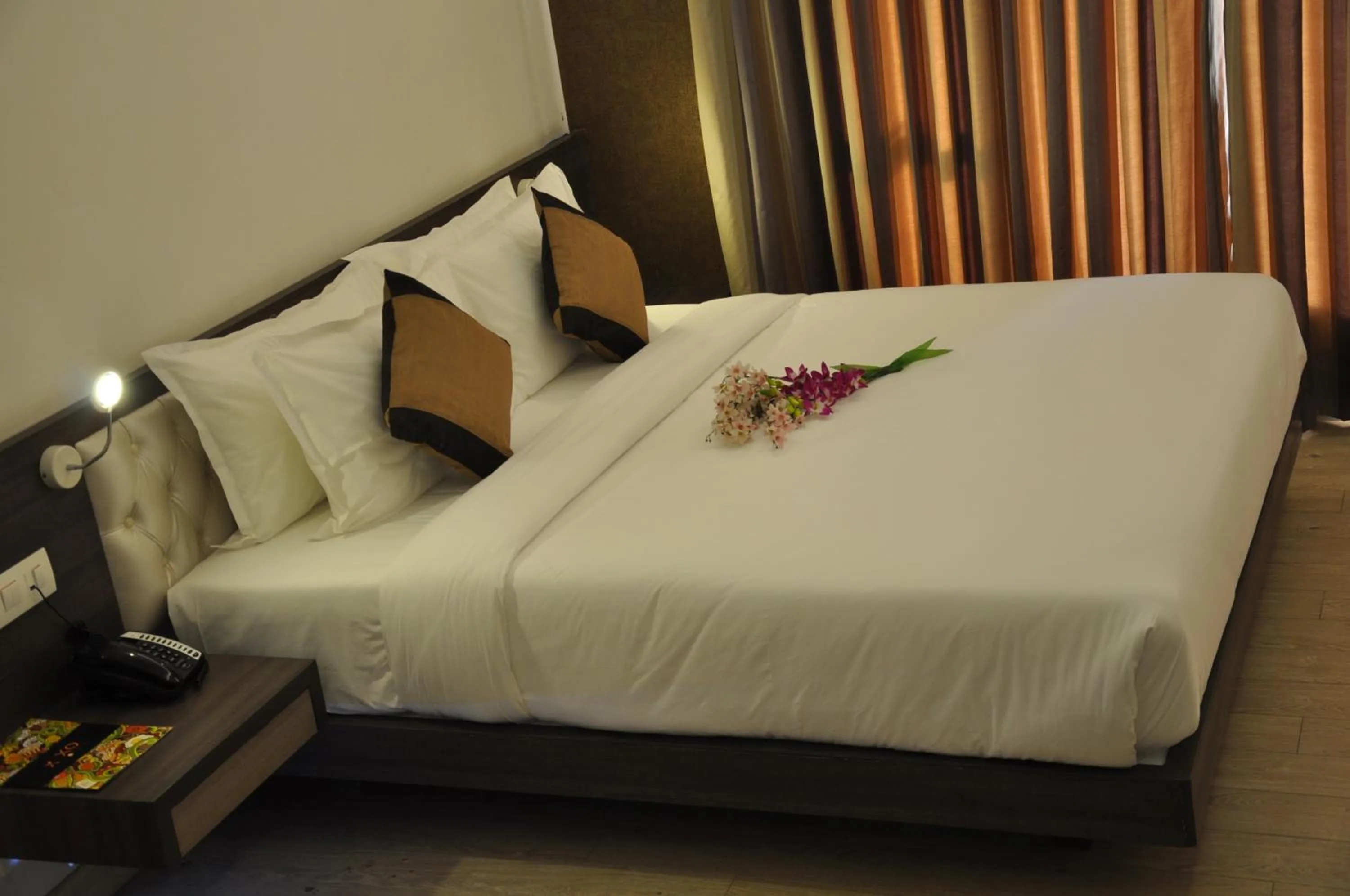 Bed in Pride Biznotel Manjusar Vadodara Near Sokhda Lake
