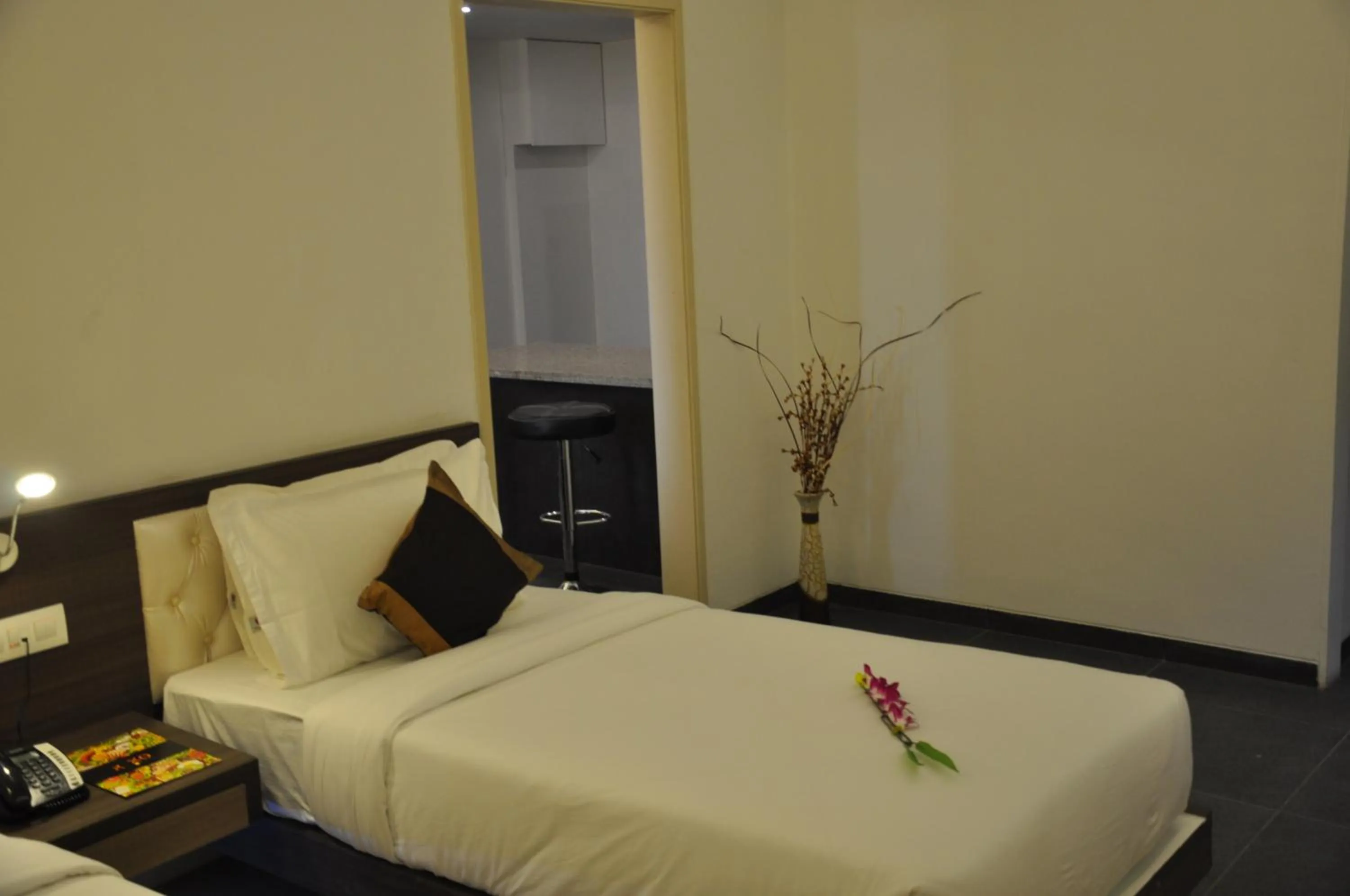 Bed in Pride Biznotel Manjusar Vadodara Near Sokhda Lake