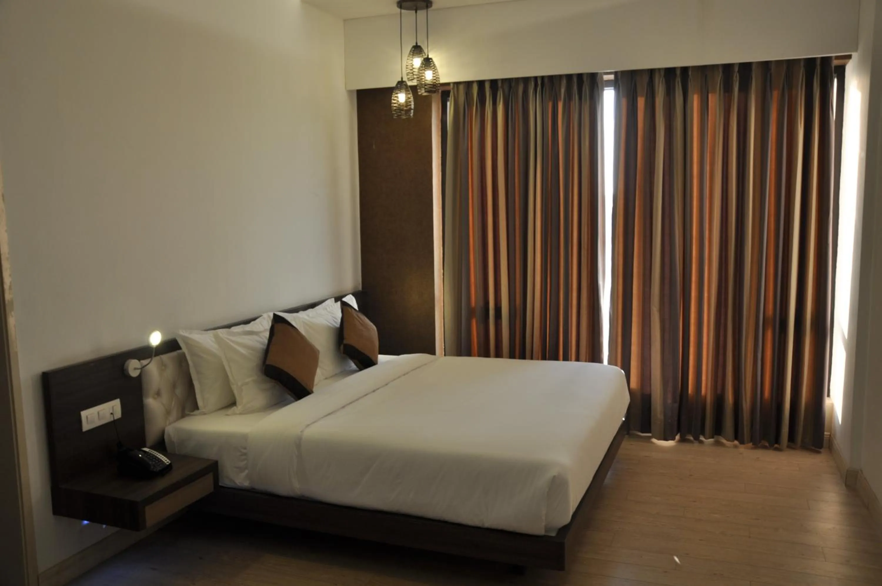 Photo of the whole room, Bed in Pride Biznotel Manjusar Vadodara Near Sokhda Lake
