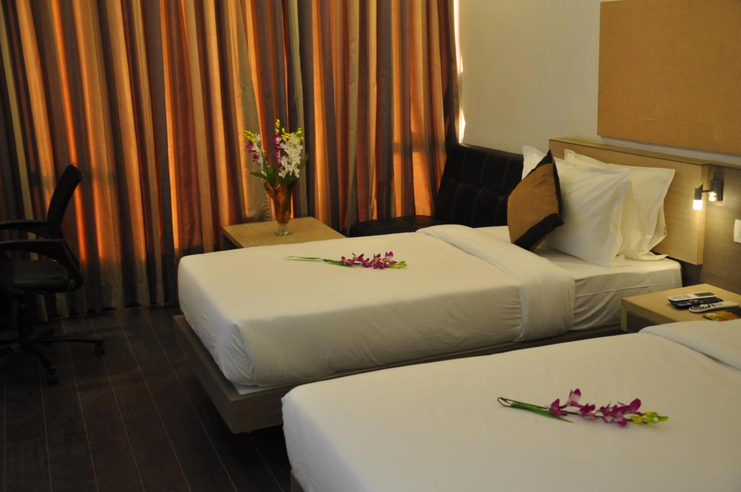 Bed in Pride Biznotel Manjusar Vadodara Near Sokhda Lake