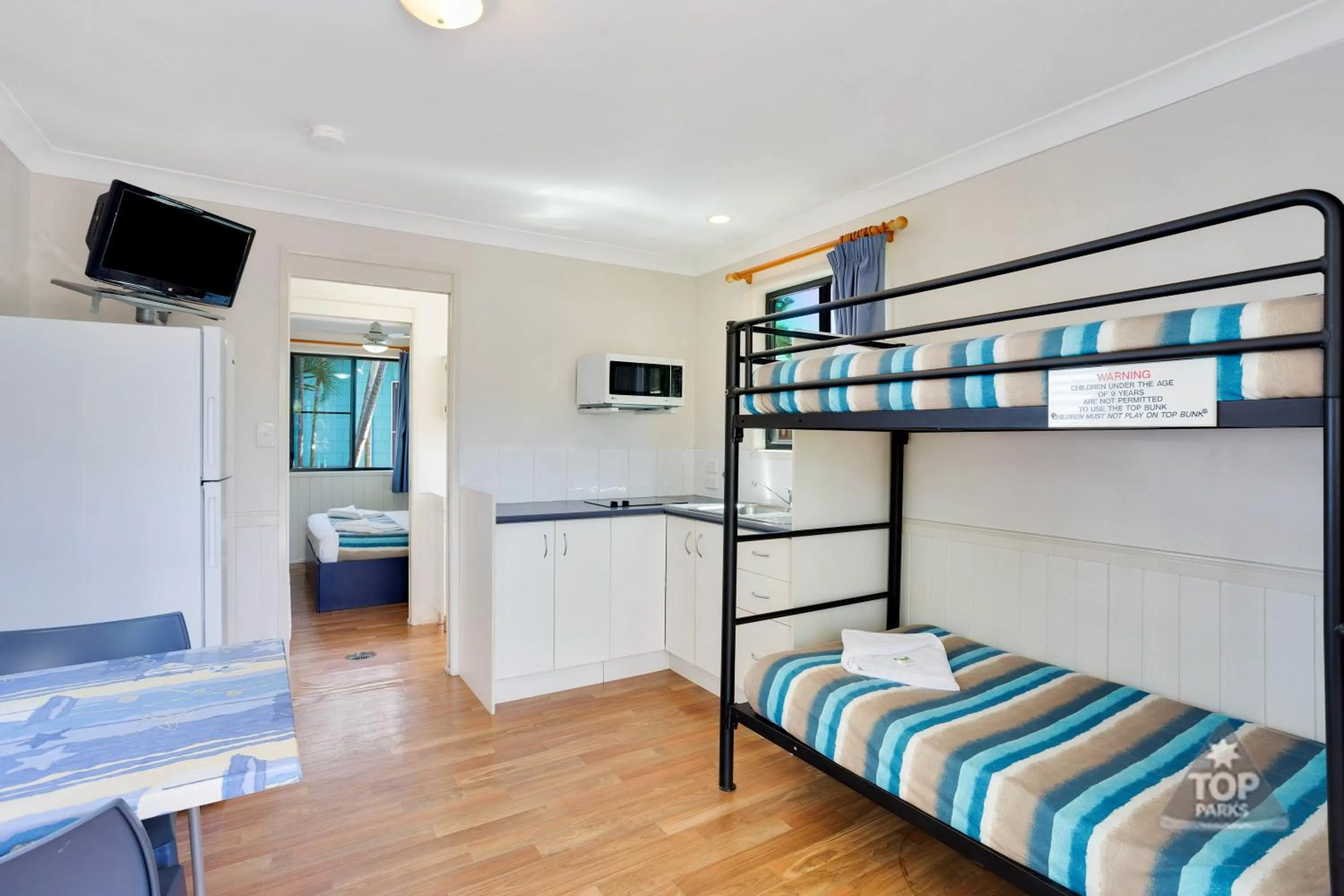 Kitchen or kitchenette, Bed in Coral Coast Tourist Park