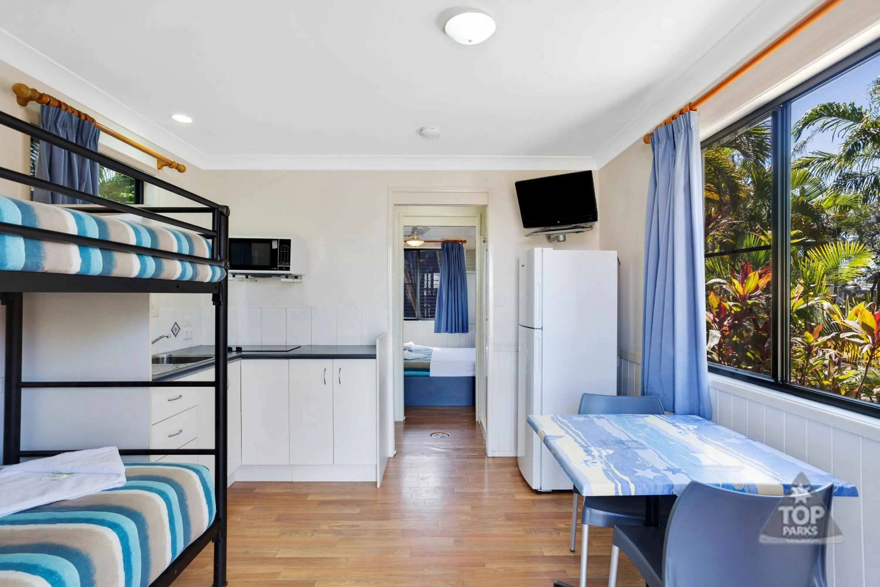 Kitchen or kitchenette, Bed in Coral Coast Tourist Park