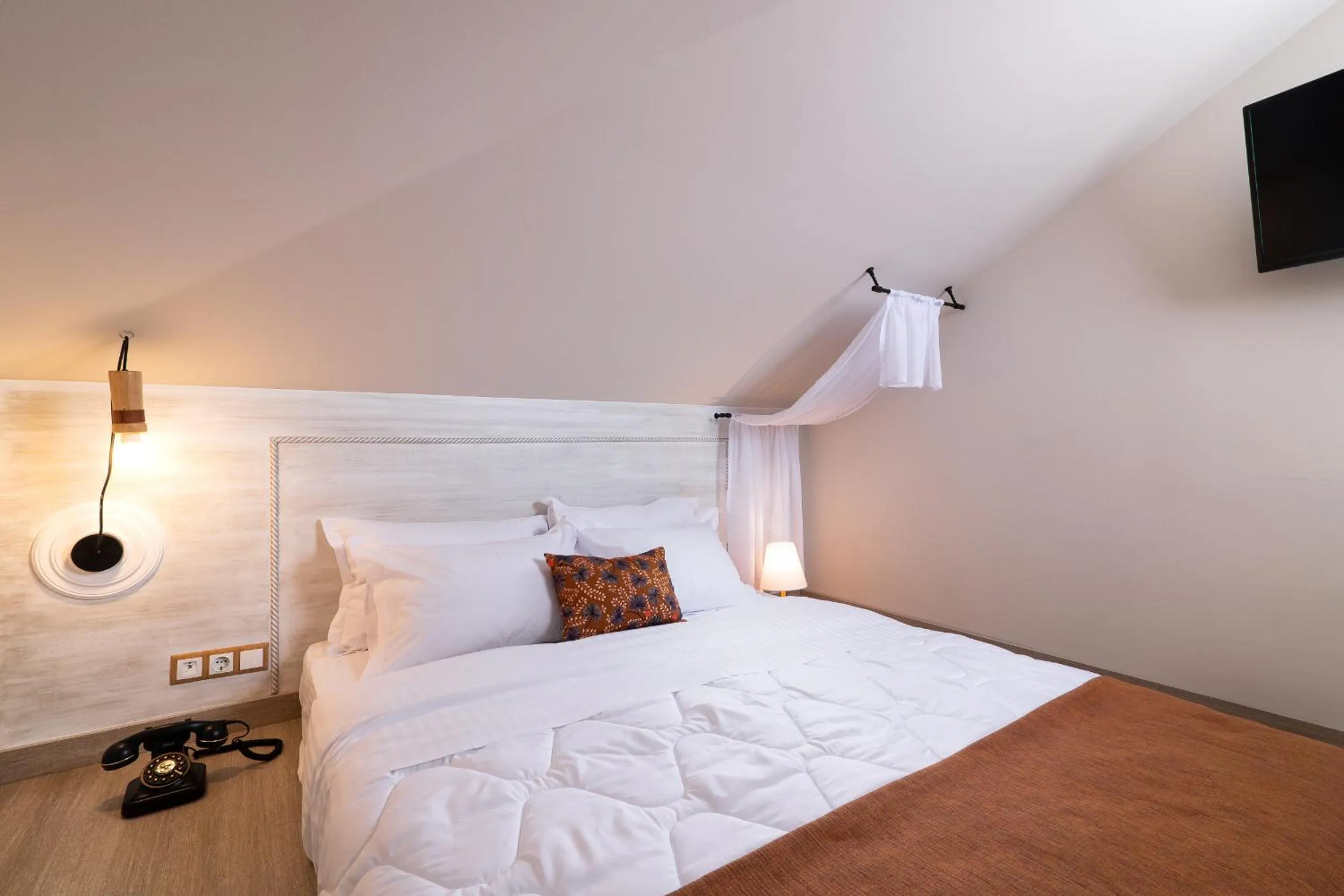 Bed in ELLE Rooms & Suites