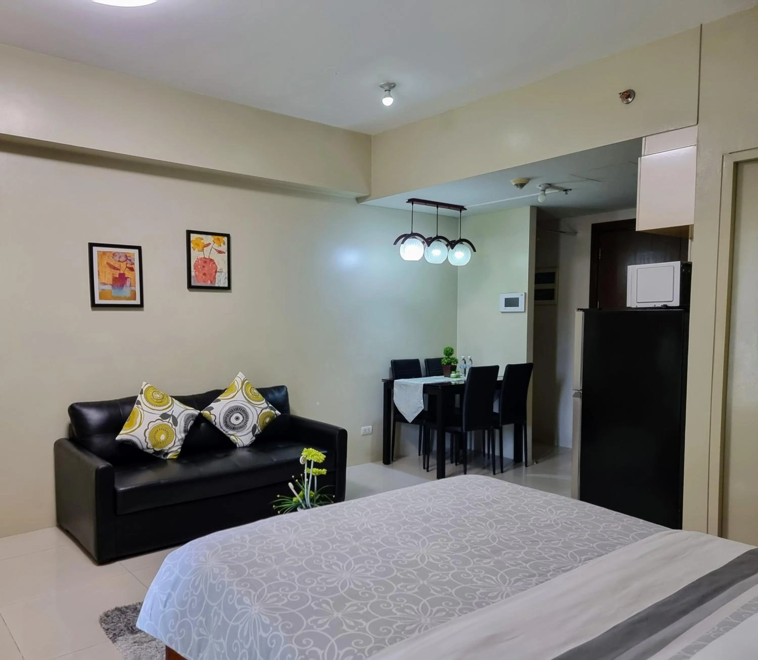 Living room, Bed in One Palm Tree Villas Condo Across NAIA Terminal 3