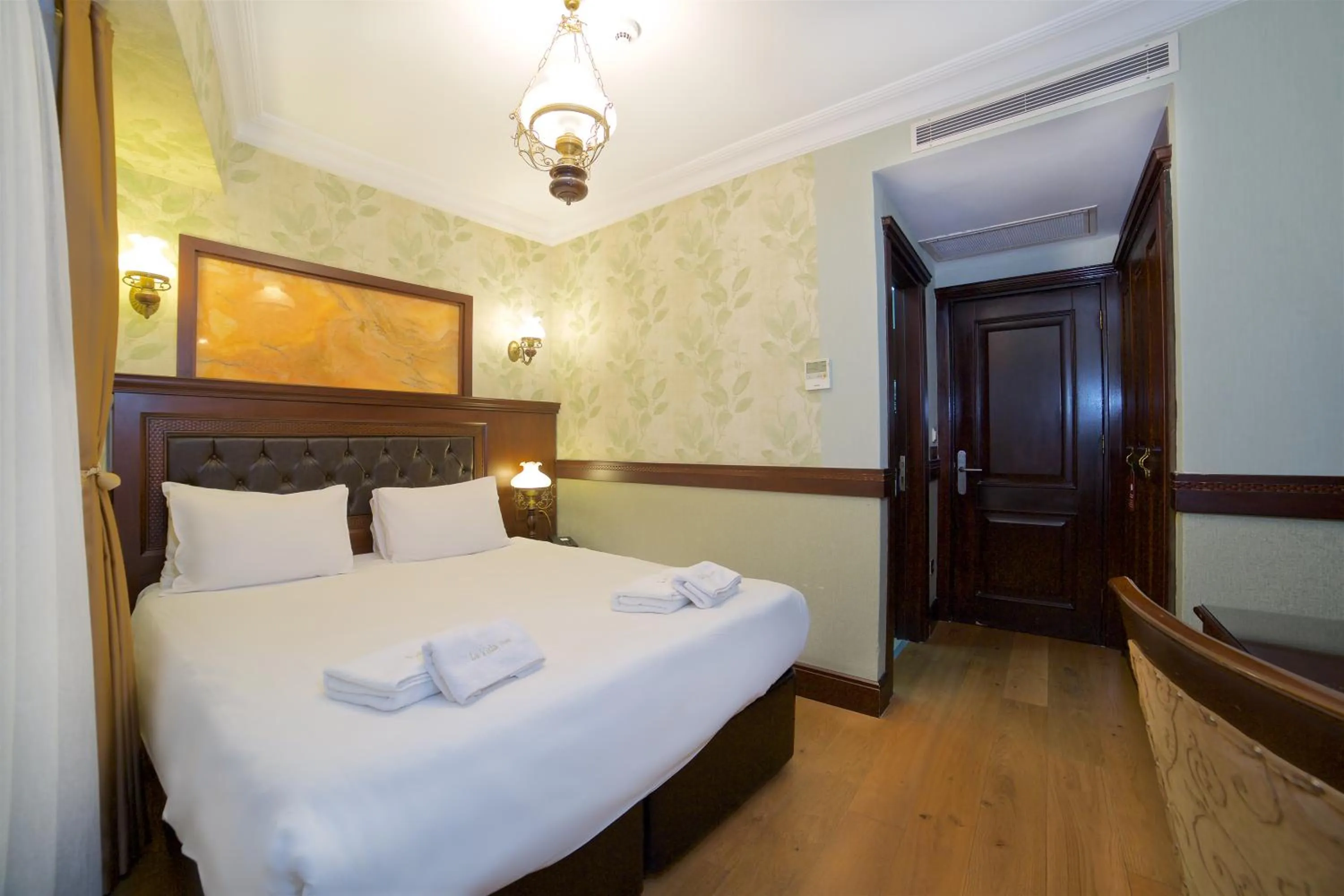 Bed in La Vida Old City Hotel