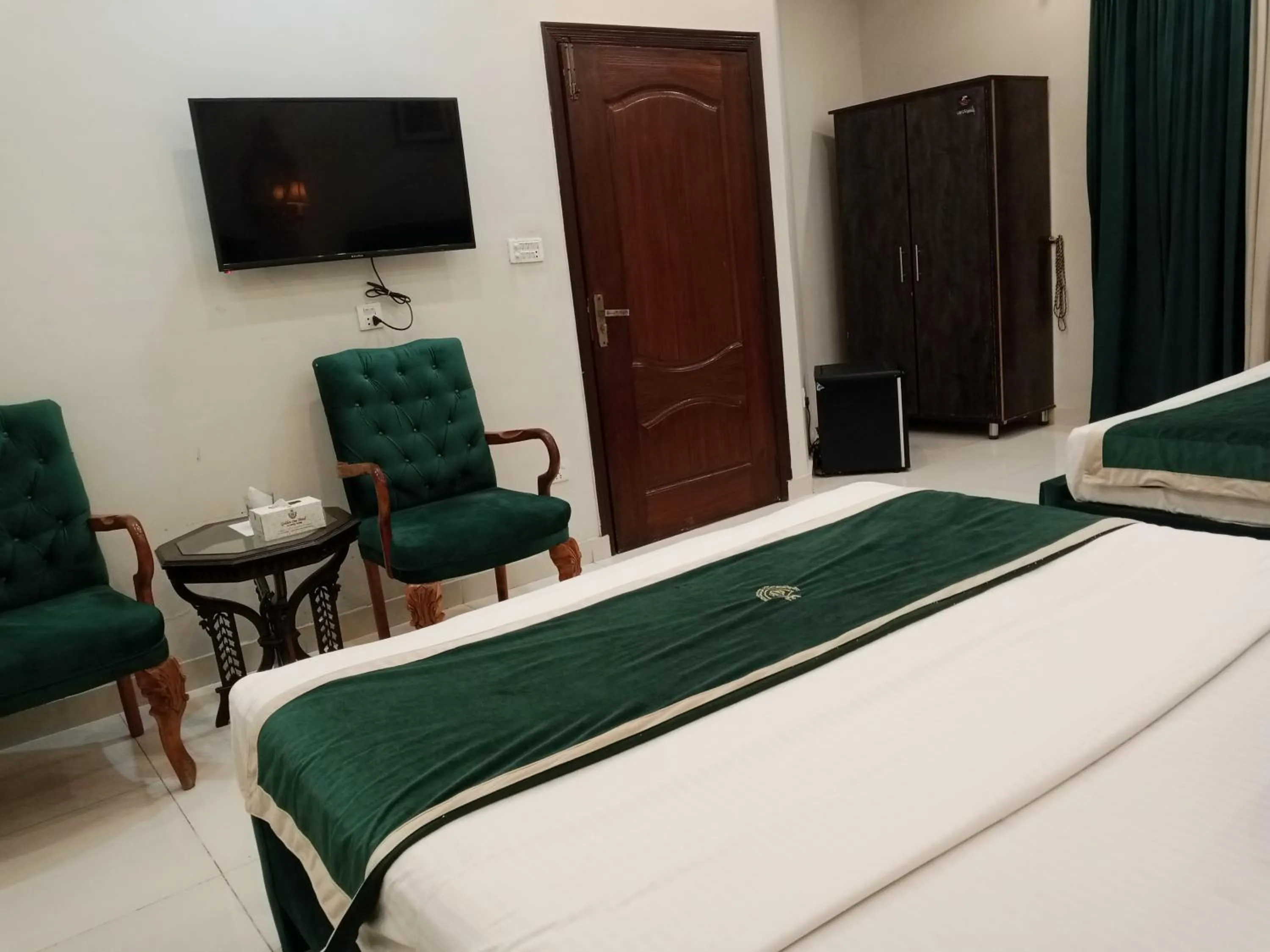 Seating area, Bed in Golden One Hotel