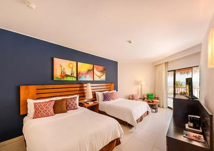 Bed in Grand Decameron Los Cabos, A Trademark All-Inclusive Resort