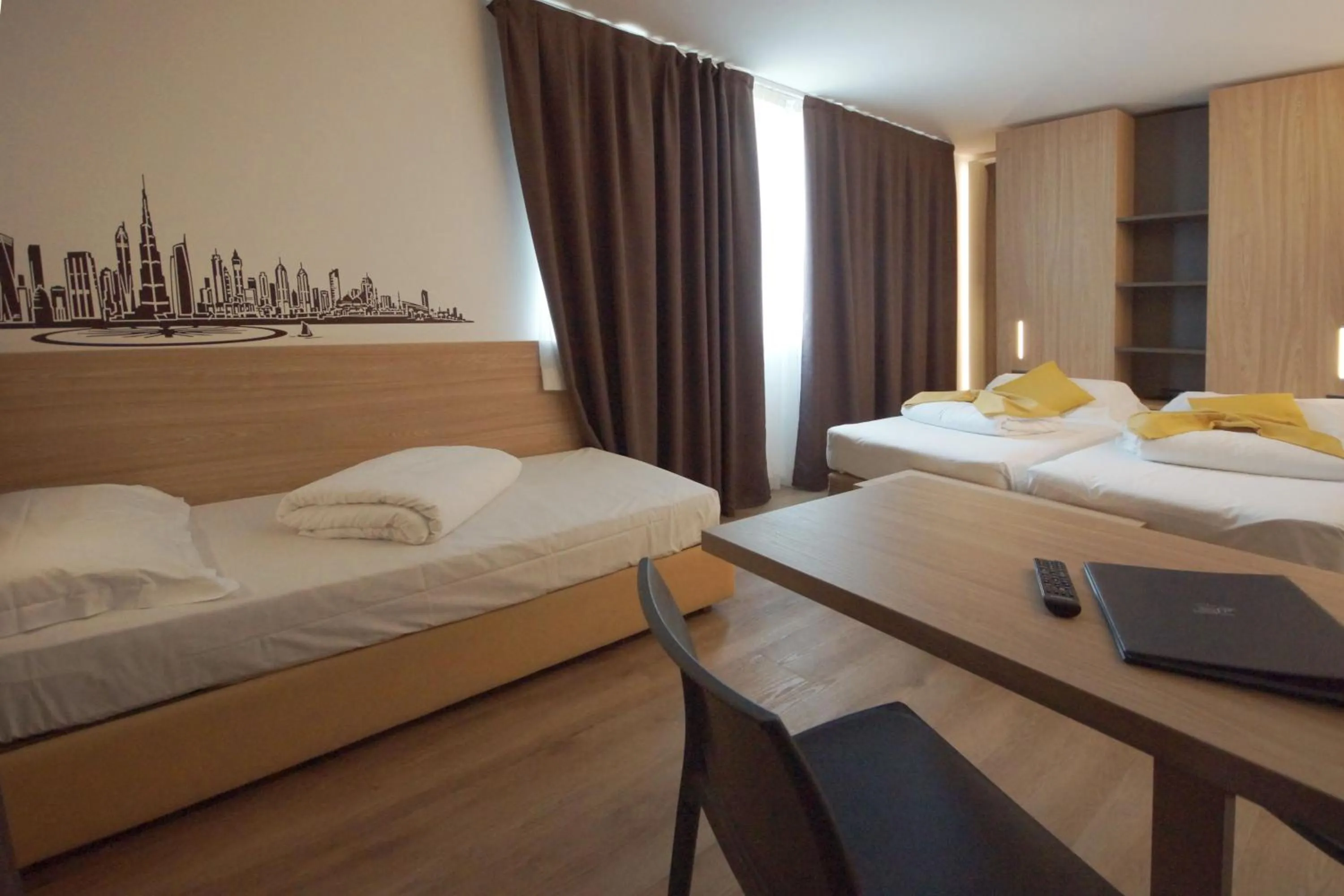 Bed in Ambassador Suite Hotel