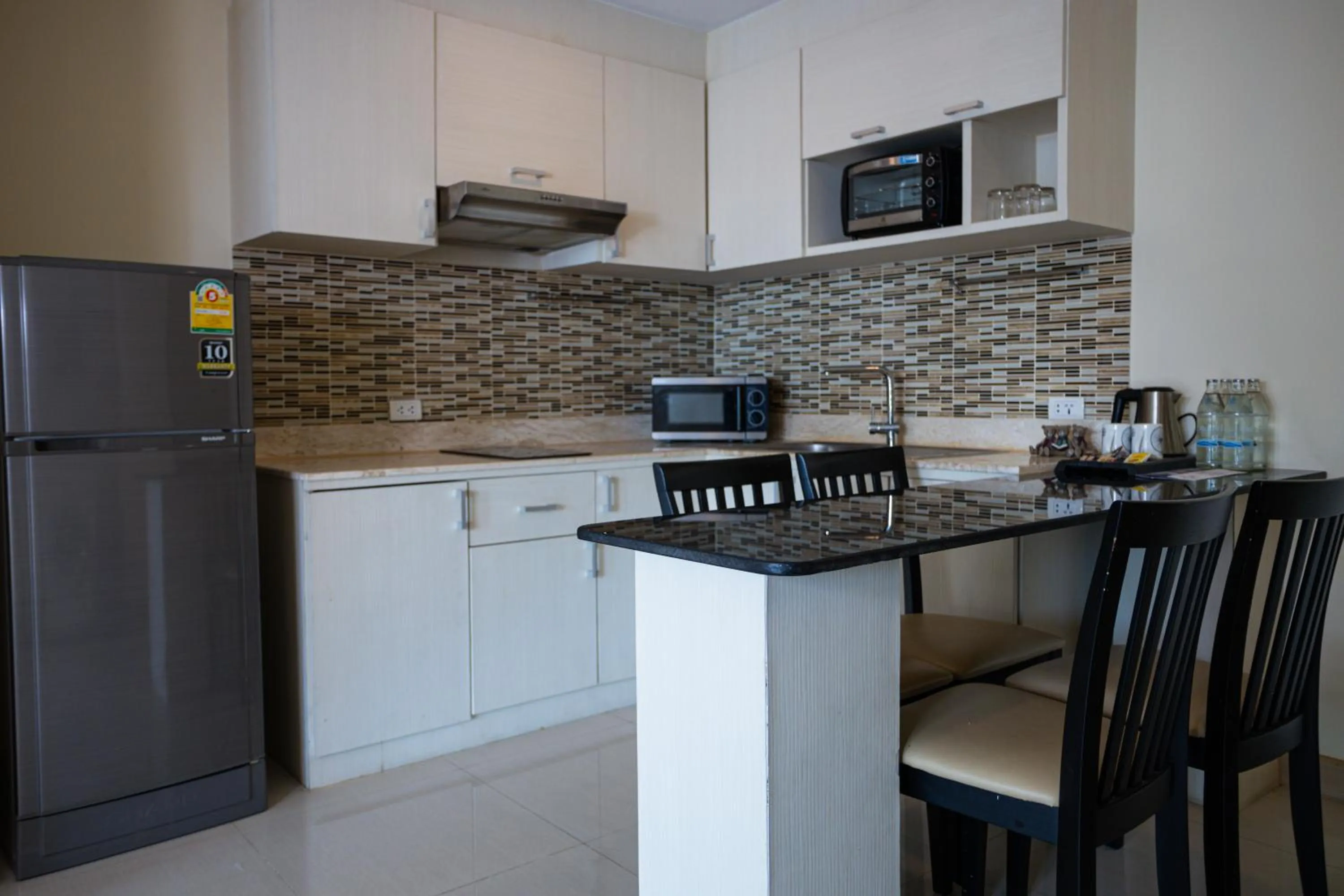 Kitchen or kitchenette in Ramada by Wyndham Bangkok Ten Ekamai Residences