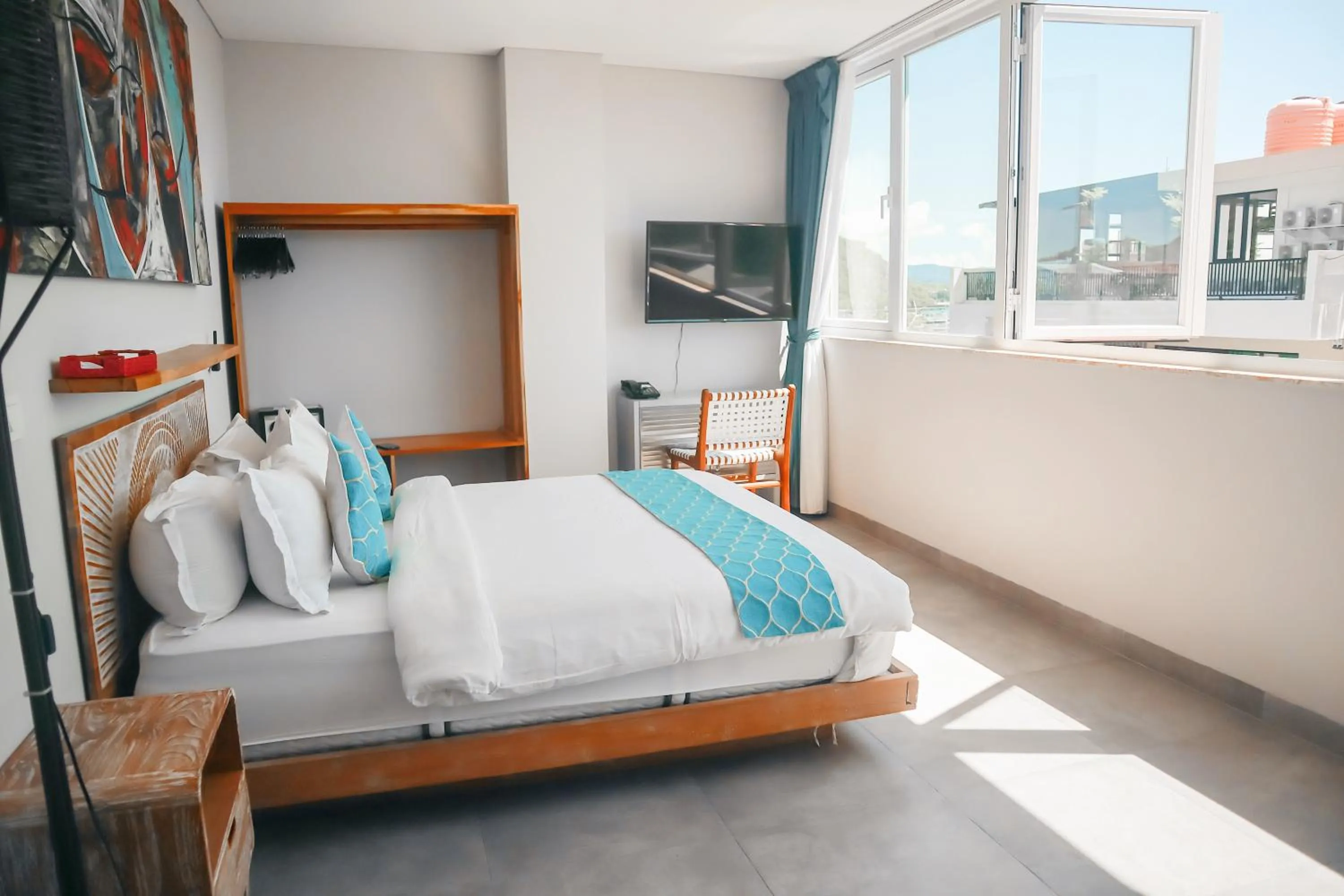 Communal lounge/ TV room, Bed in Harbour Komodo Hotel