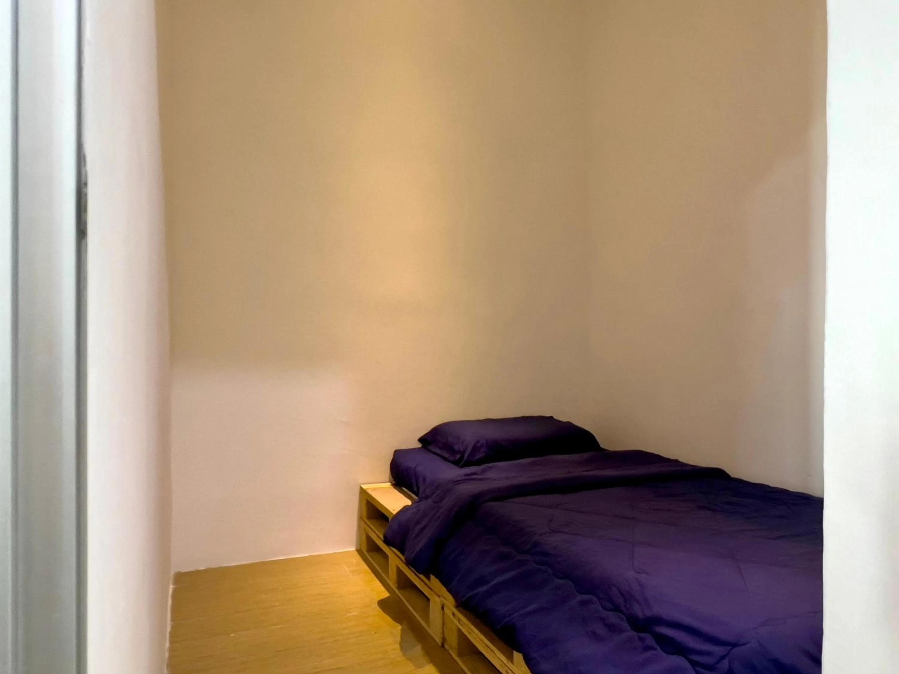 Bed in Hush Inn at ITCC Manhattan Suites