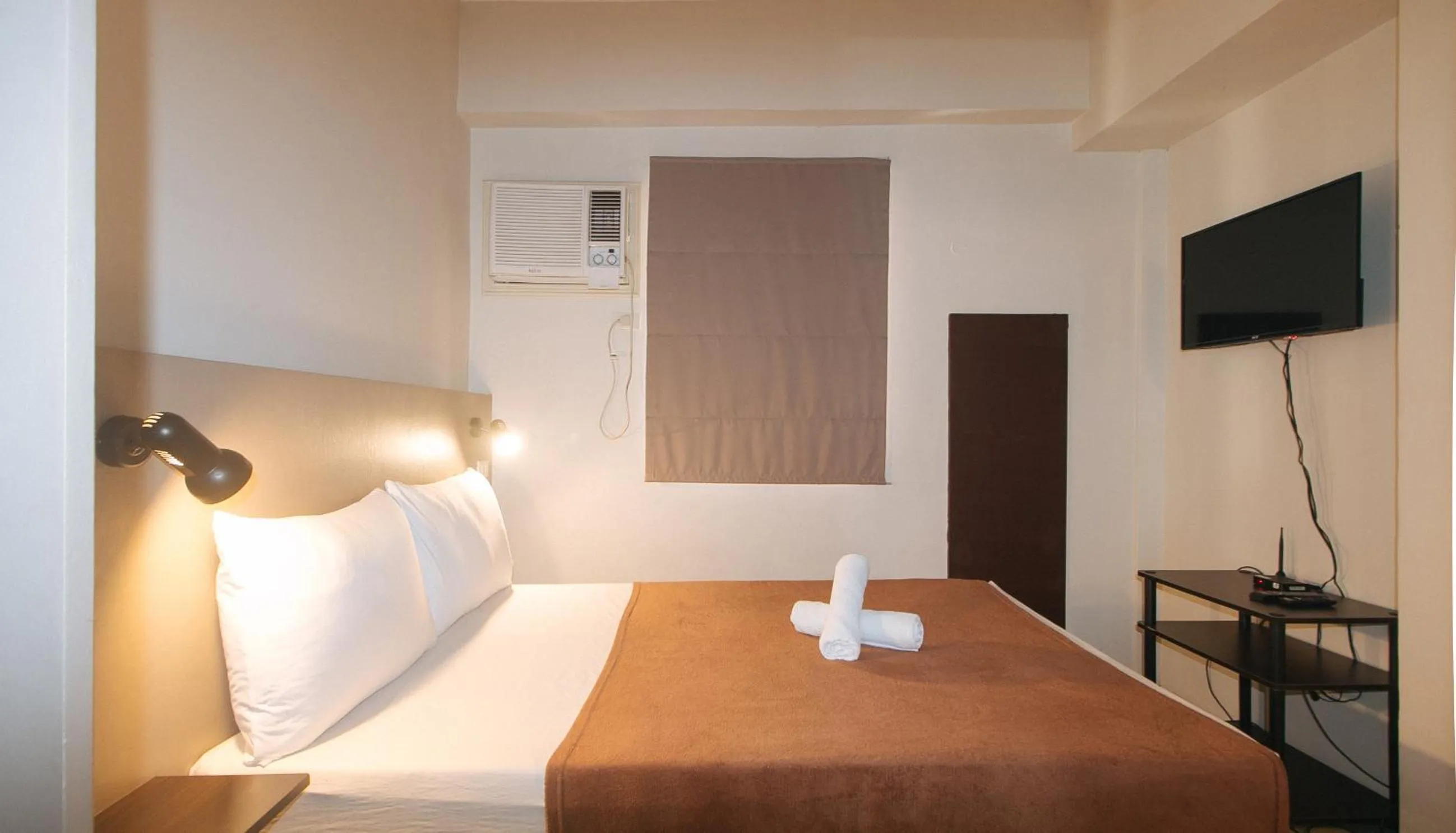 Bed in 59 Xavierville by RedDoorz