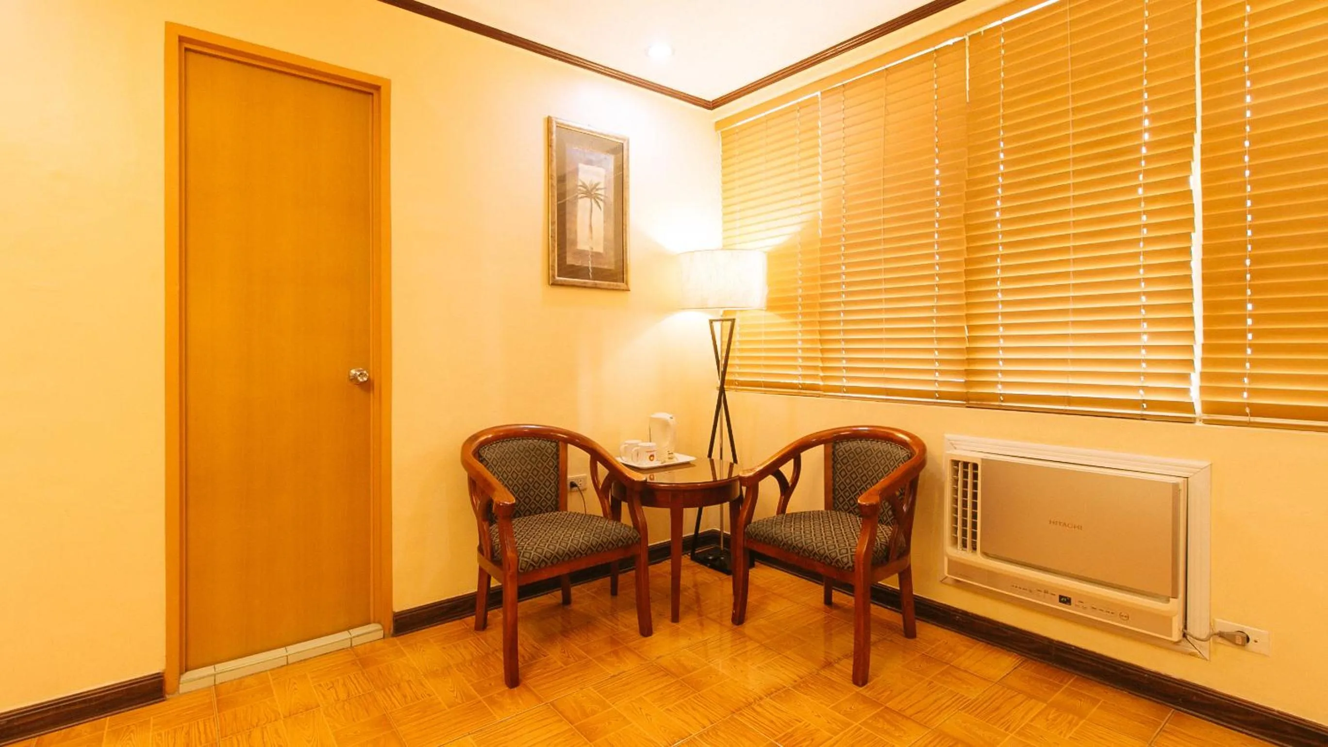 Seating area in Peace Hotel by RedDoorz