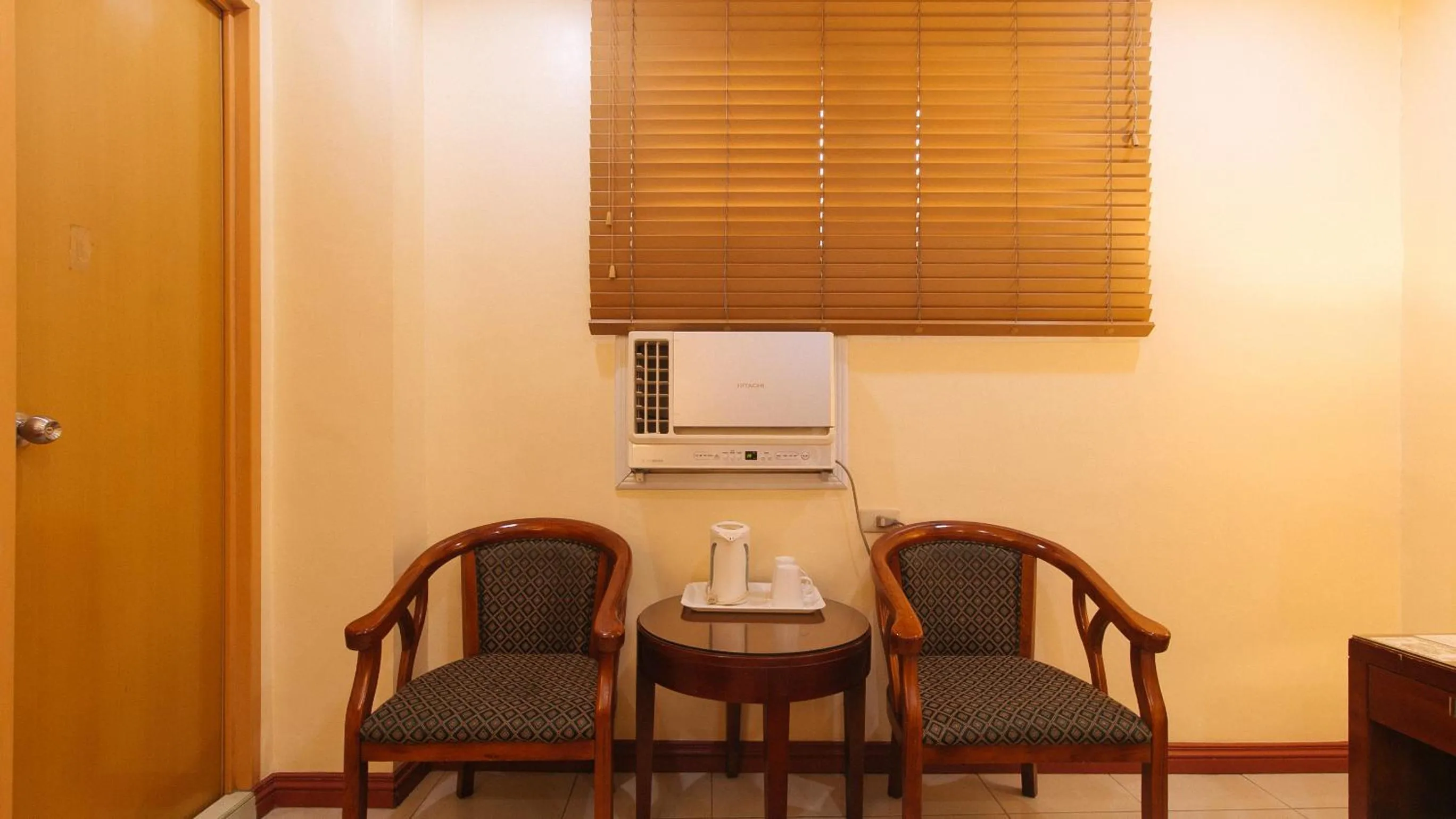 Seating area in Peace Hotel by RedDoorz