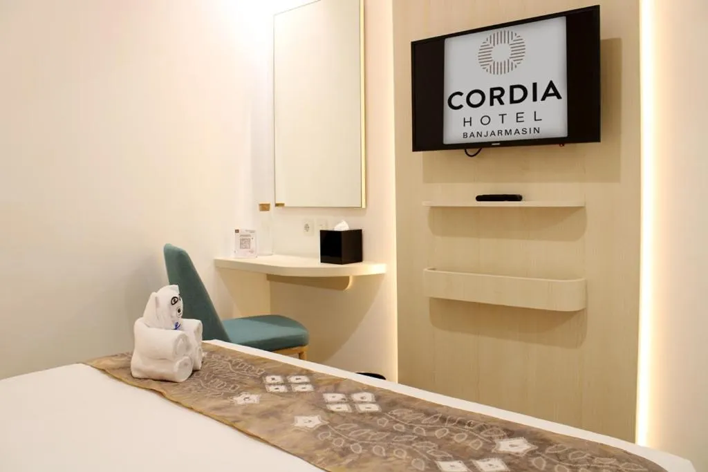 Communal lounge/ TV room, Bed in Cordia Hotel Banjarmasin - Hotel Dalam Bandara