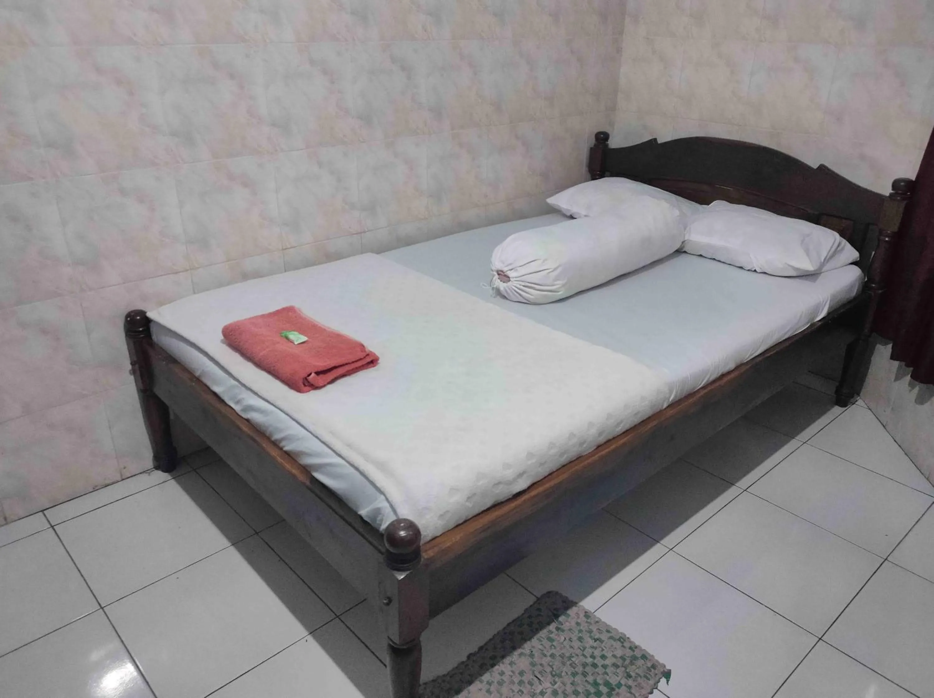 Bed in Penginapan Mentorogo Kaliurang Mitra RedDoorz