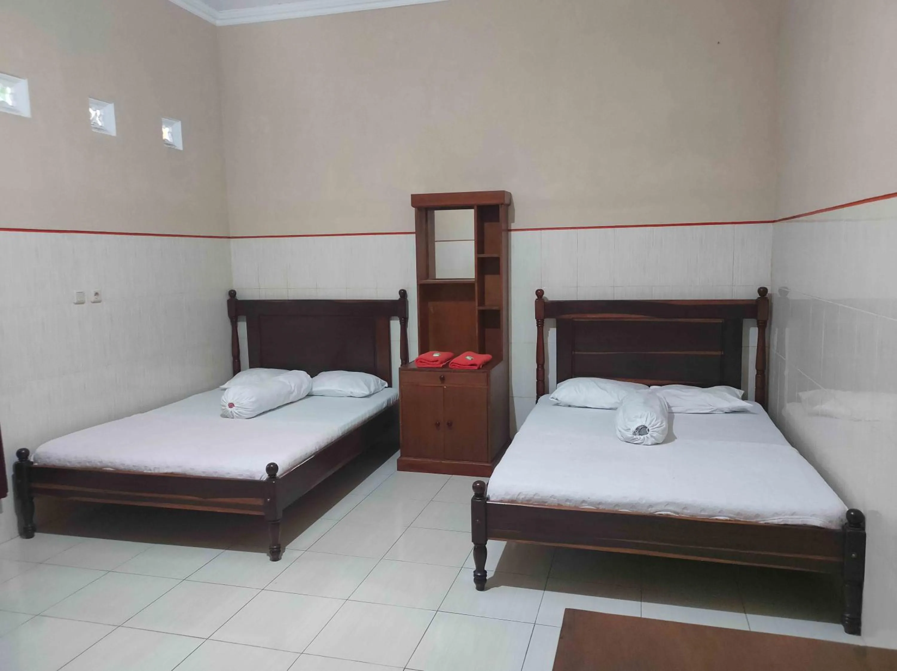 Bed in Penginapan Mentorogo Kaliurang Mitra RedDoorz