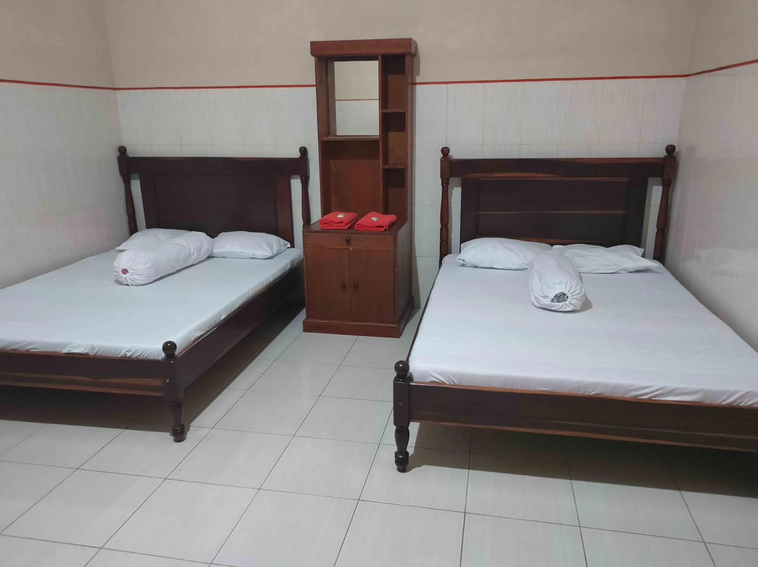 Bed in Penginapan Mentorogo Kaliurang Mitra RedDoorz