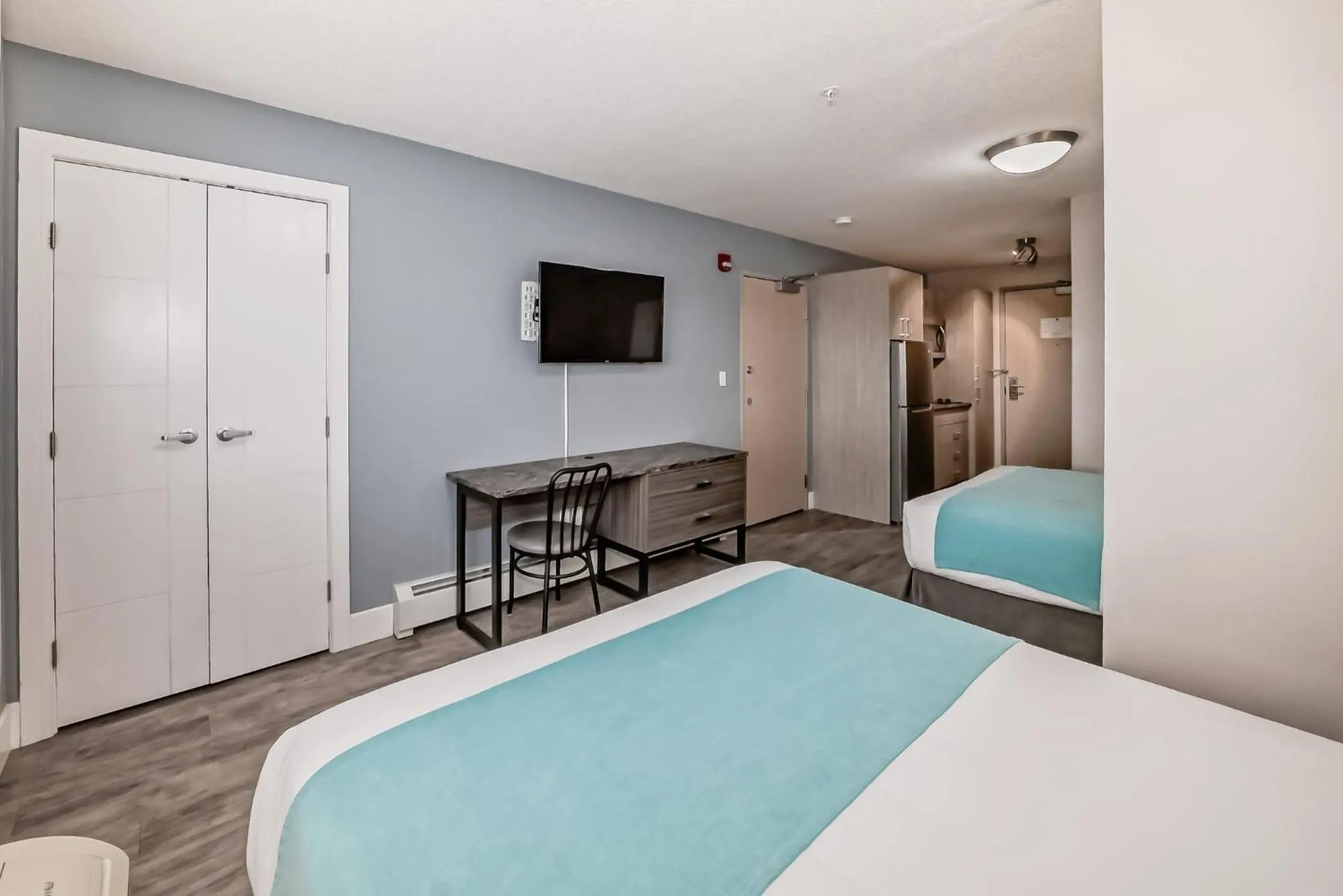 Bed in The Suites, INN Hotels